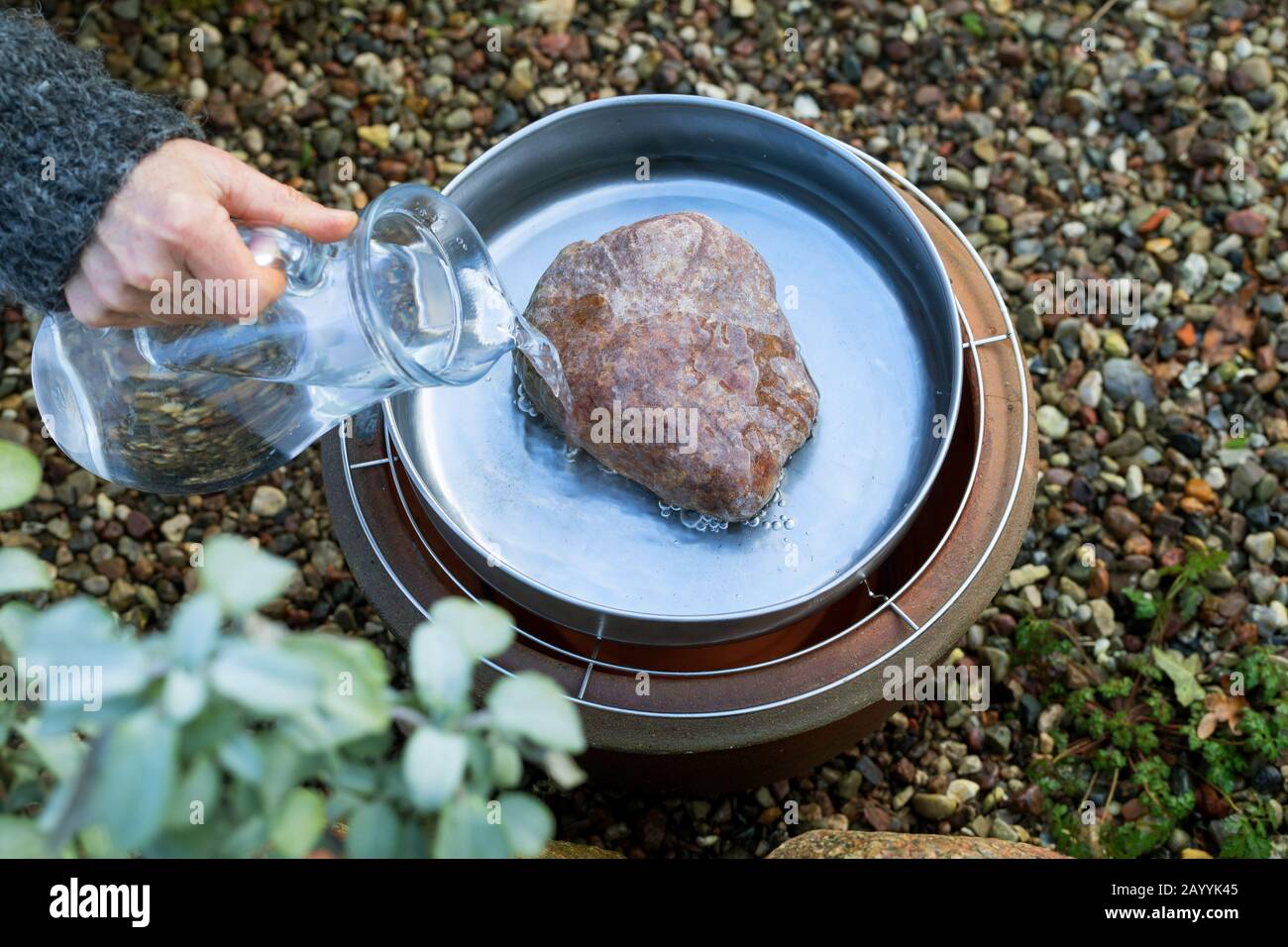 frost-free drinking trough, made of flower pot, saucer, grave candle, cooling rack and fireproof bowl, Germany Stock Photo