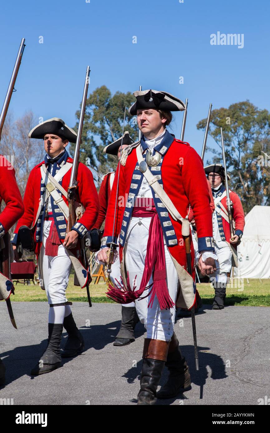 British redcoat soldiers marching during a reenactment of the American revolution  in "Huntington central  park" Huntington Beach California USA Stock Photo