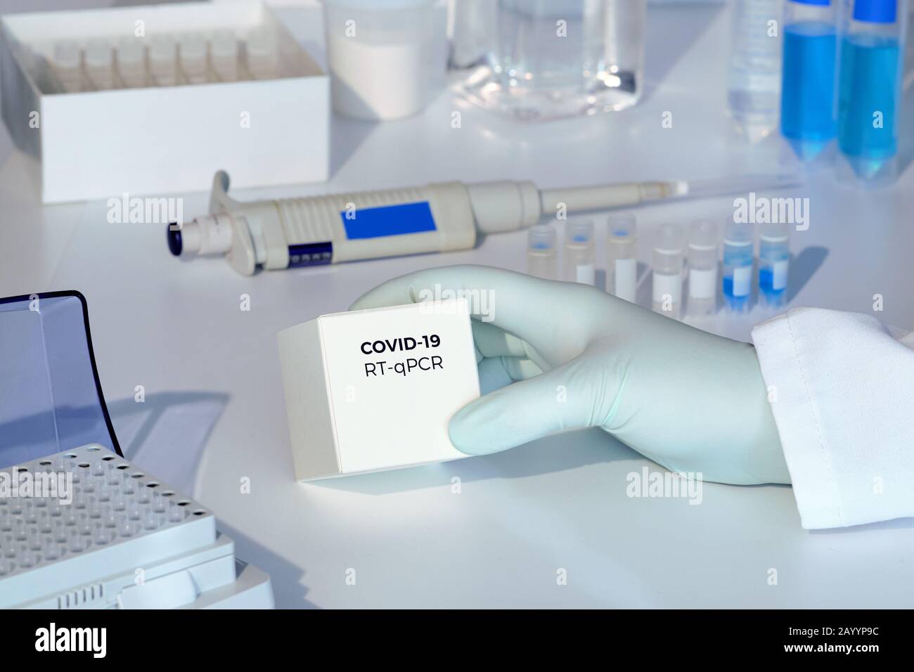 Quick novel COVID-19 coronavirus test kit. 2019 nCoV pcr diagnostics kit. Hand in glove with the box. RT-PCR kit to detect covid19 virus in clinical s Stock Photo