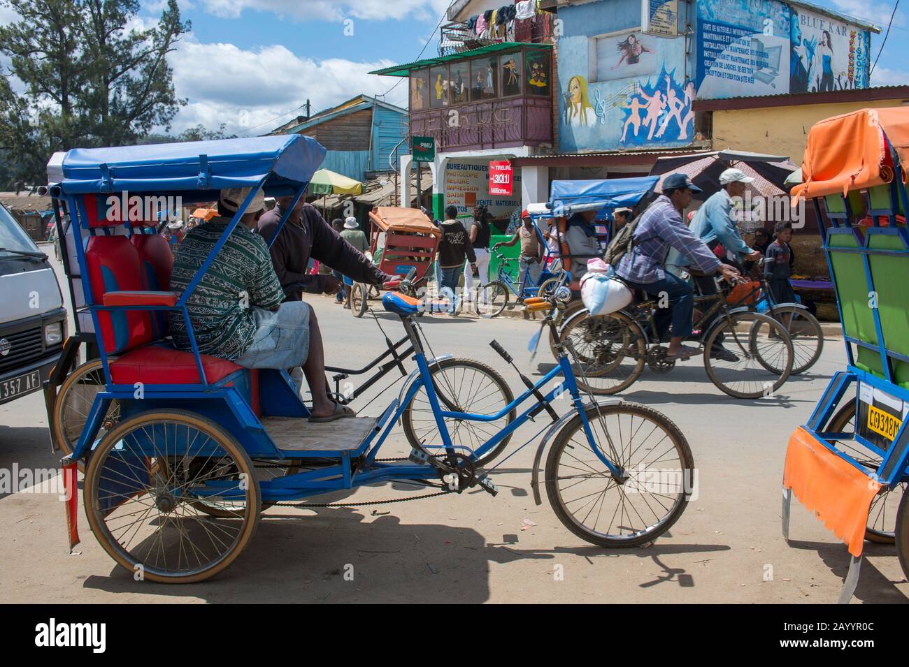 Street scene with bicycle rickshaws in Moramanga, Madagascar. Stock Photo