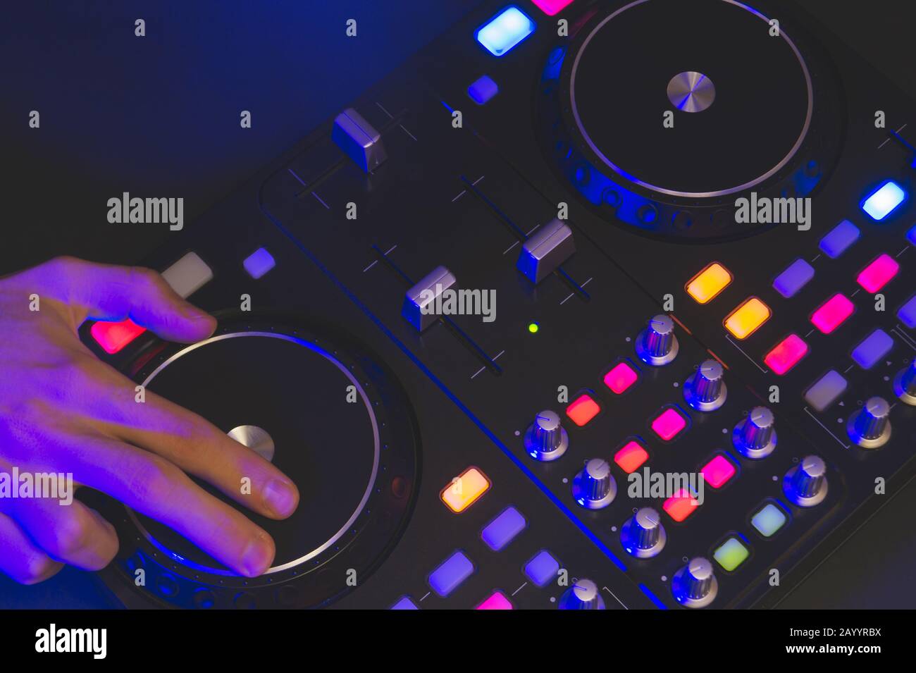 DJ plays music. sound mixer controller with knobs and sliders close up