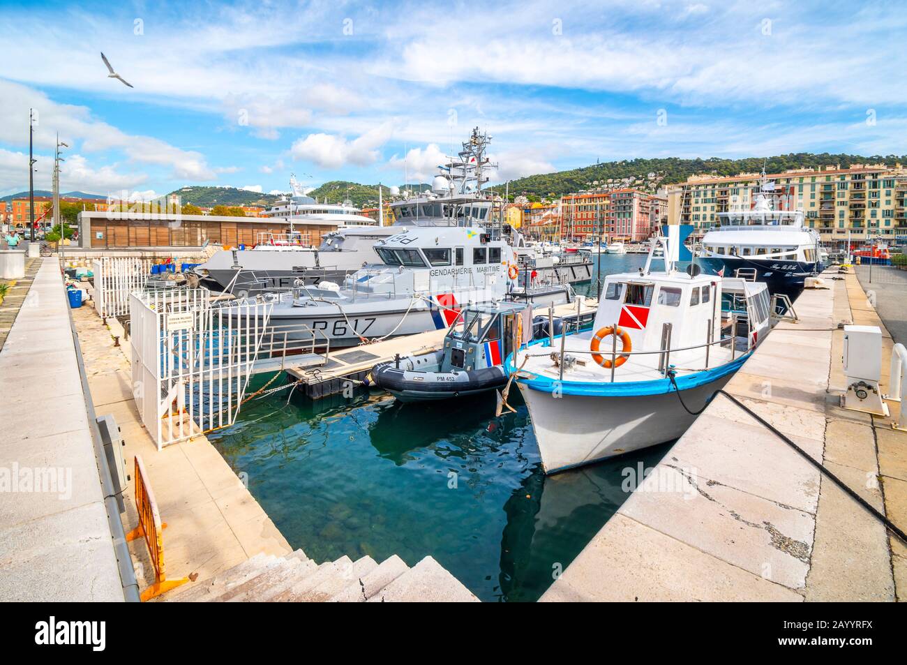 An assortment of boats and watercraft in the old harbor of Port Lympia in the city of Nice France, on the Mediterranean Sea at the French Riviera. Stock Photo