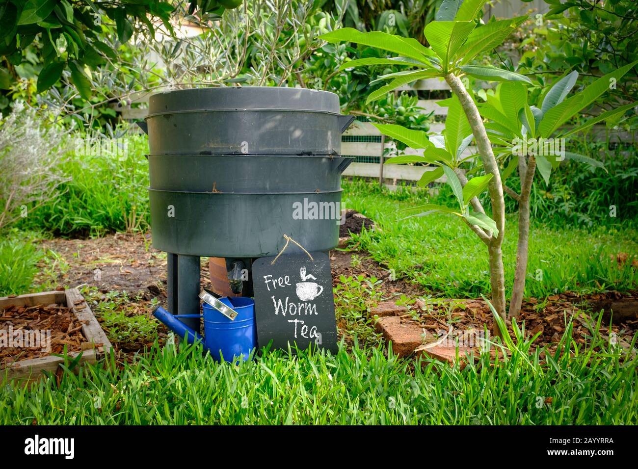 worm farm compost bin in organic Australian garden with sign for Free