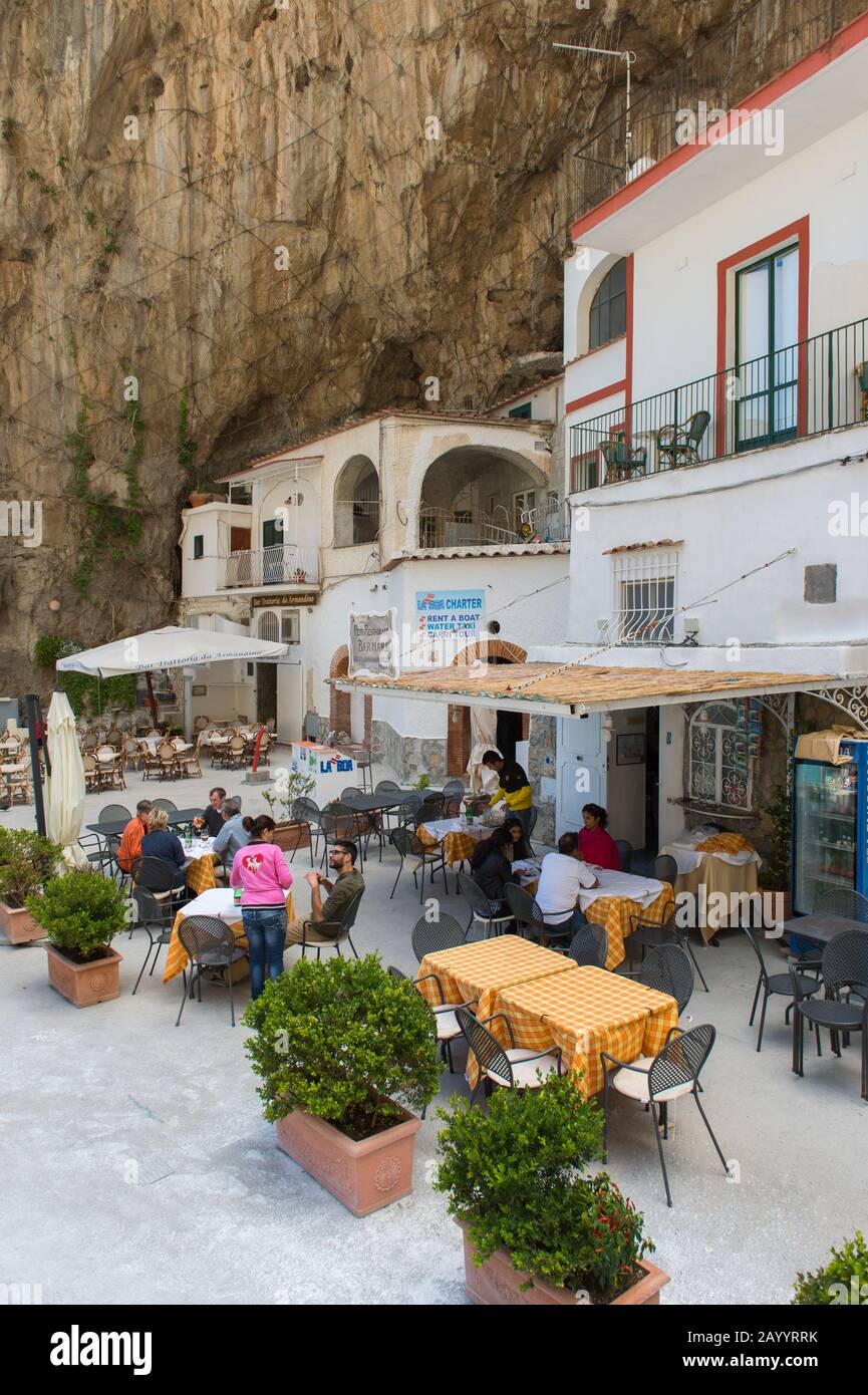 Restaurants in a bay at Praiano, a community of the province of Salerno in  the Campania region of southwest Italy and is situated on the Amalfi Coast  Stock Photo - Alamy