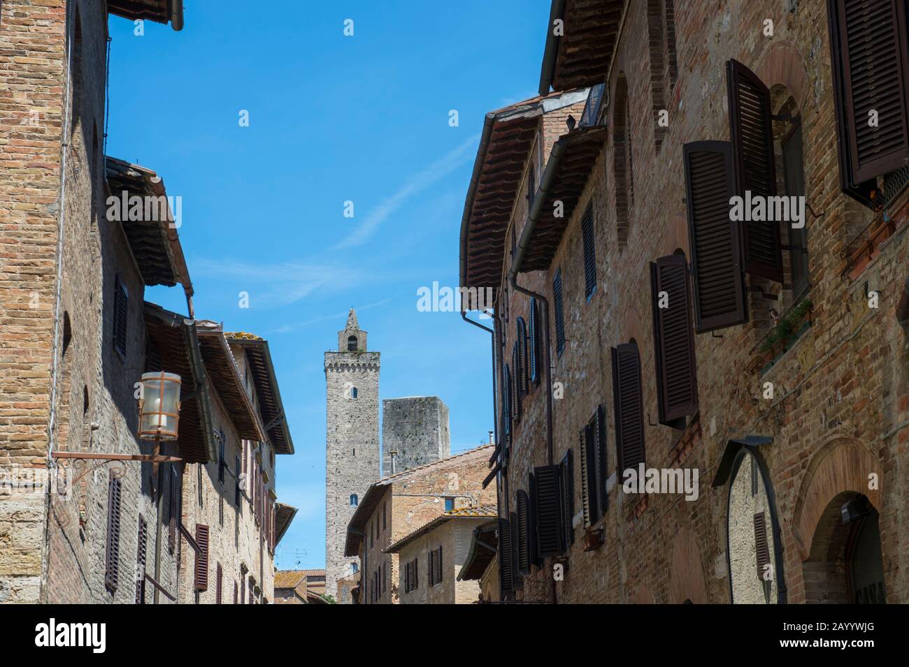 Street scene with towers in the medieval walled hill town of San Gimignano in Tuscany, Italy. Stock Photo
