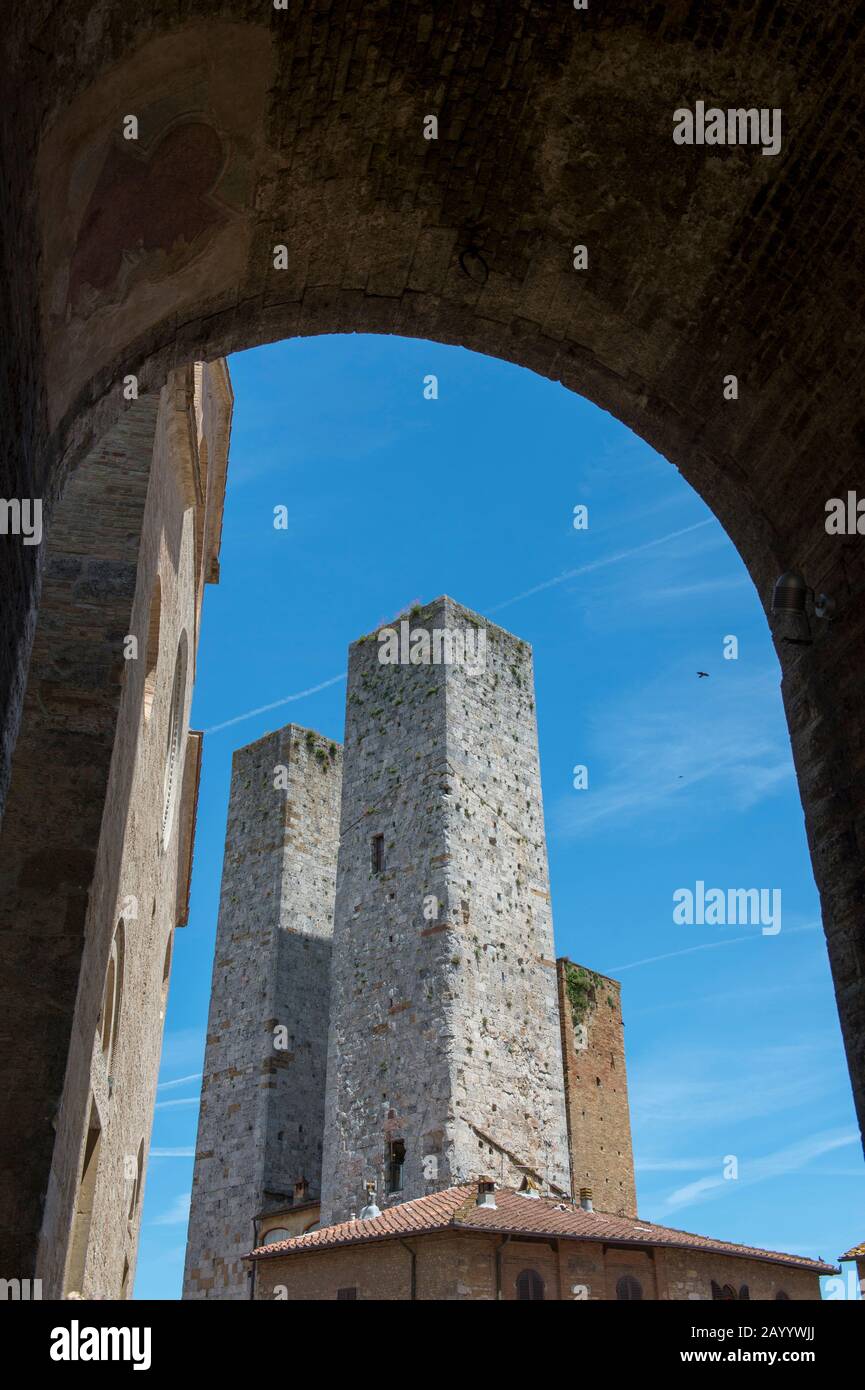 Street scene with towers in the medieval walled hill town of San Gimignano in Tuscany, Italy. Stock Photo