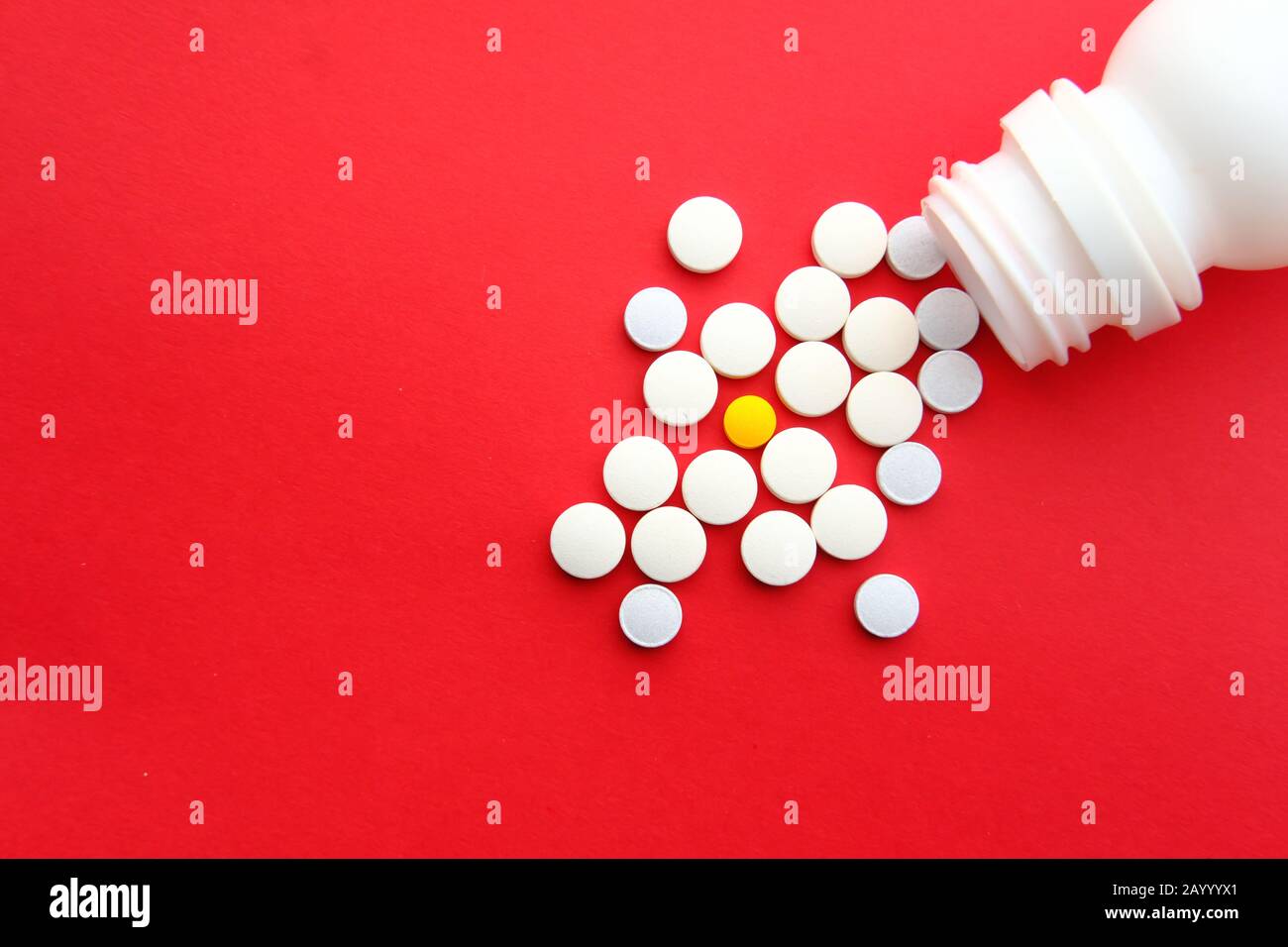 Close up of pills on table on red background  Stock Photo