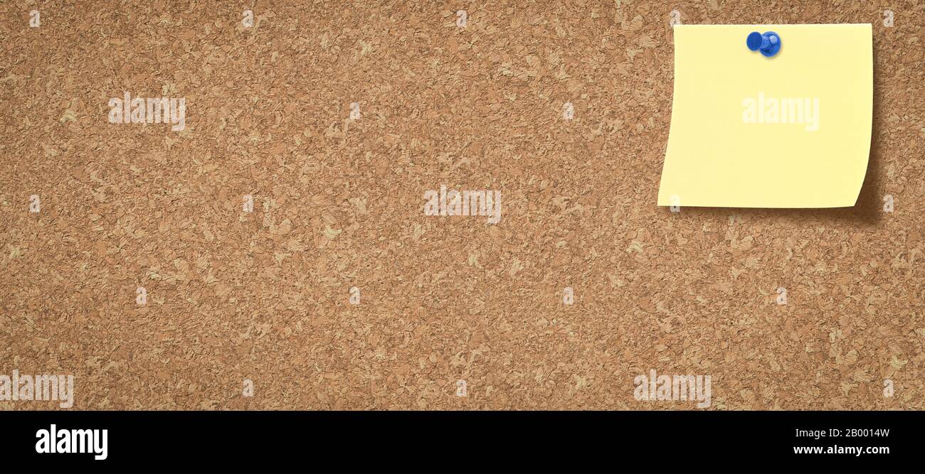 cork board with a colored blank note pinned on it Stock Photo