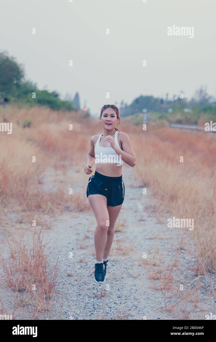 Athlete Thai woman running at the country road. Asian female runner endurance  training in summer. Heathy lifestyle and sport recreation Stock Photo -  Alamy