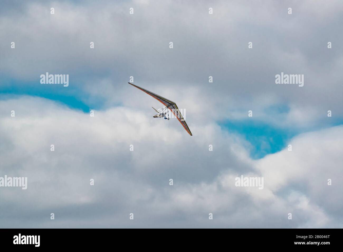 2020-02-09 Byshiv, Ukraine. Lonely hang glider soar in the blue sky Stock Photo