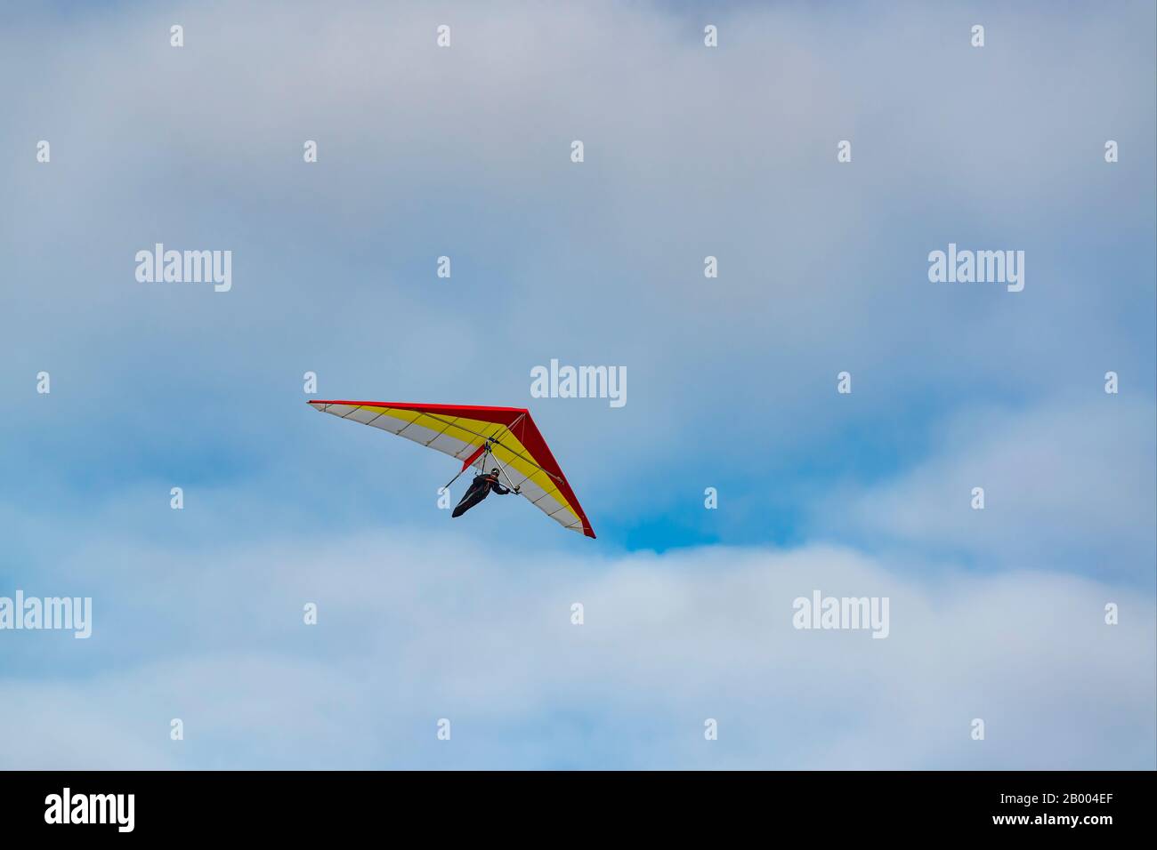 2020-02-09 Byshiv, Ukraine. Lonely red hang glider soar in the blue sky Stock Photo