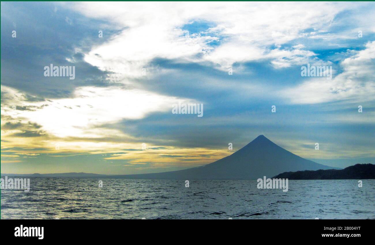 Mayon Volcano or Mt. Mayon is a sacred and active stratovolcano. Renowned  for its perfect cone, it is a popular tourist destination. Stock Photo