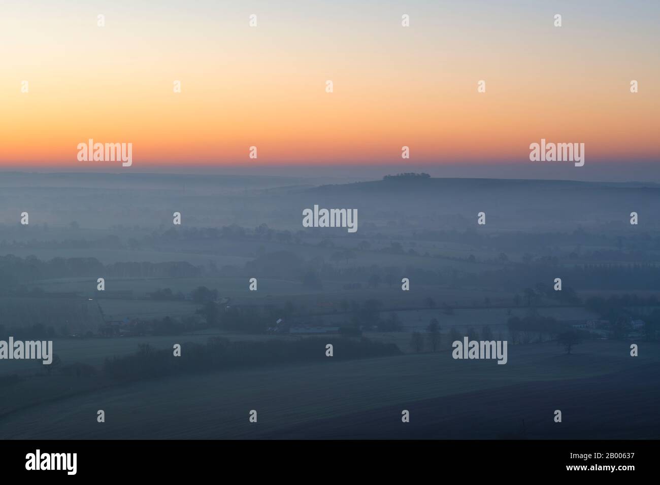 View from Martinsell Hill on a foggy winter morning at sunrise. Near Oare, Vale of Pewsey, Wiltshire, England Stock Photo