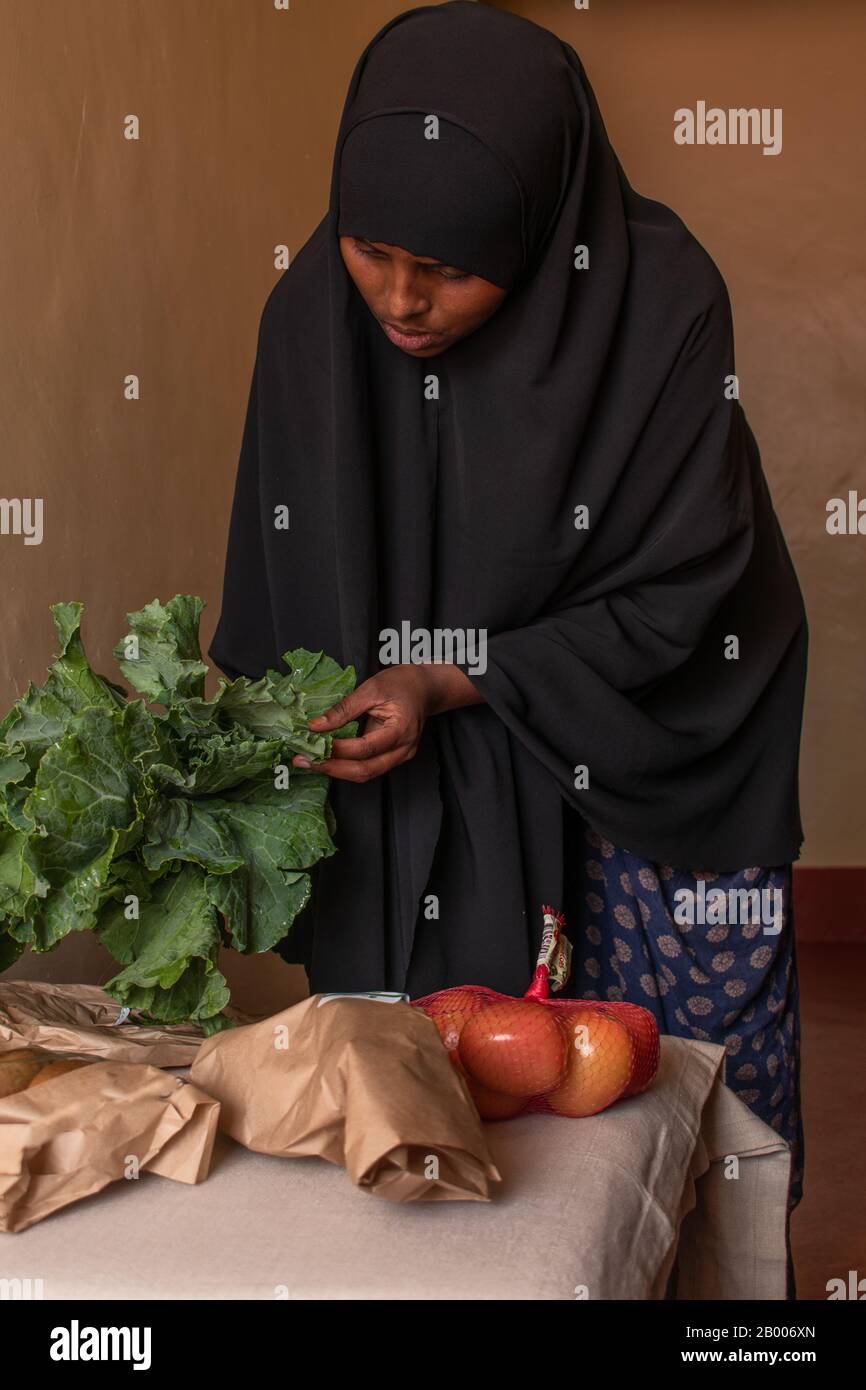 a young Somali Muslim woman unpacking groceries at home Stock Photo