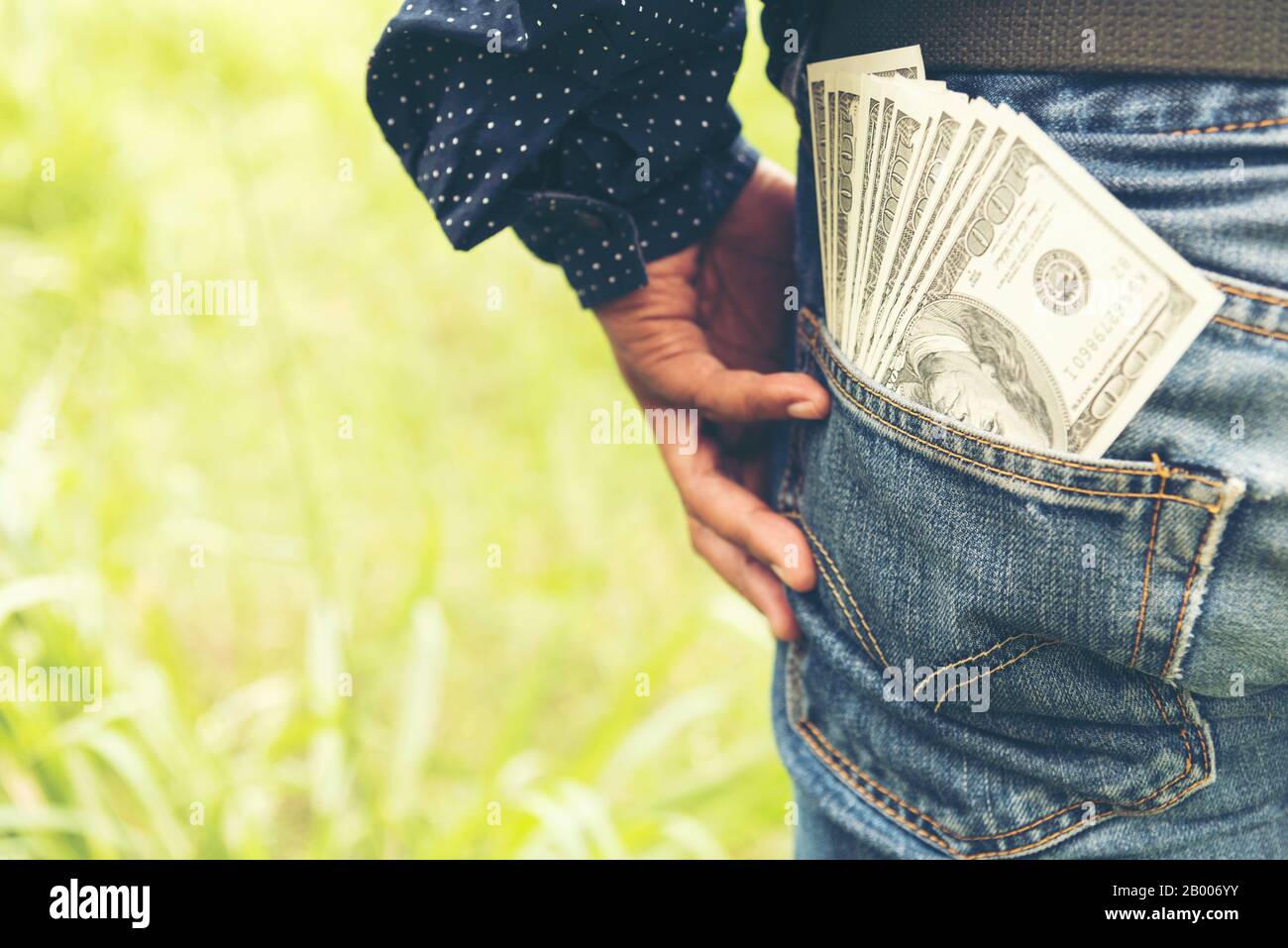 Cutting money lost in Finance Problems man with dollar bank note money in back pocket. financial concept. Stock Photo