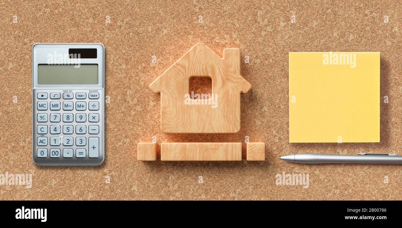 house symbol on cork background with office items Stock Photo