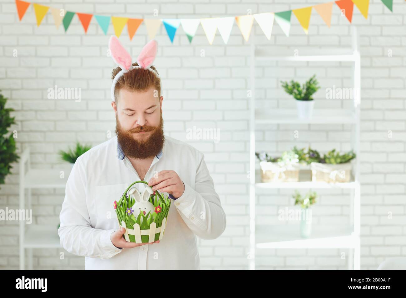 Happy easter. Funny male bearded man smiling on easter background Stock Photo