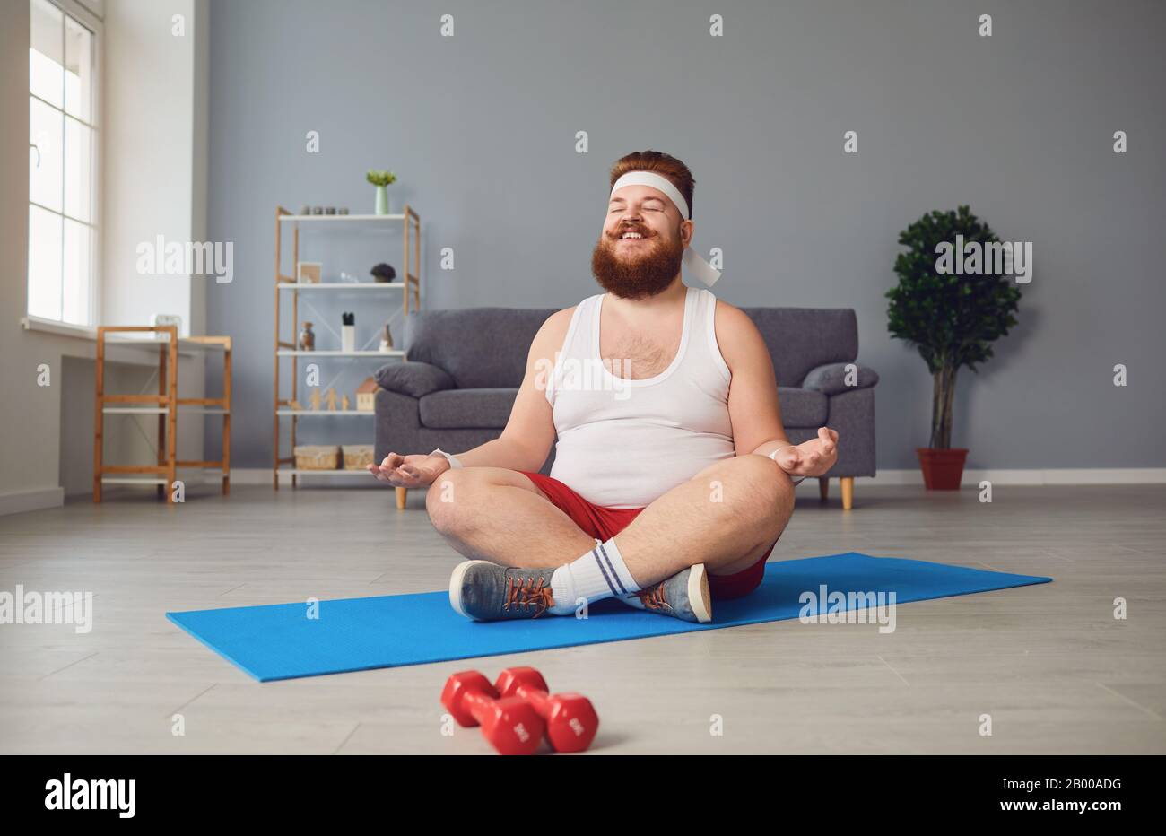 Funny yoga. Fat man doing yoga exercises in the room Stock Photo - Alamy