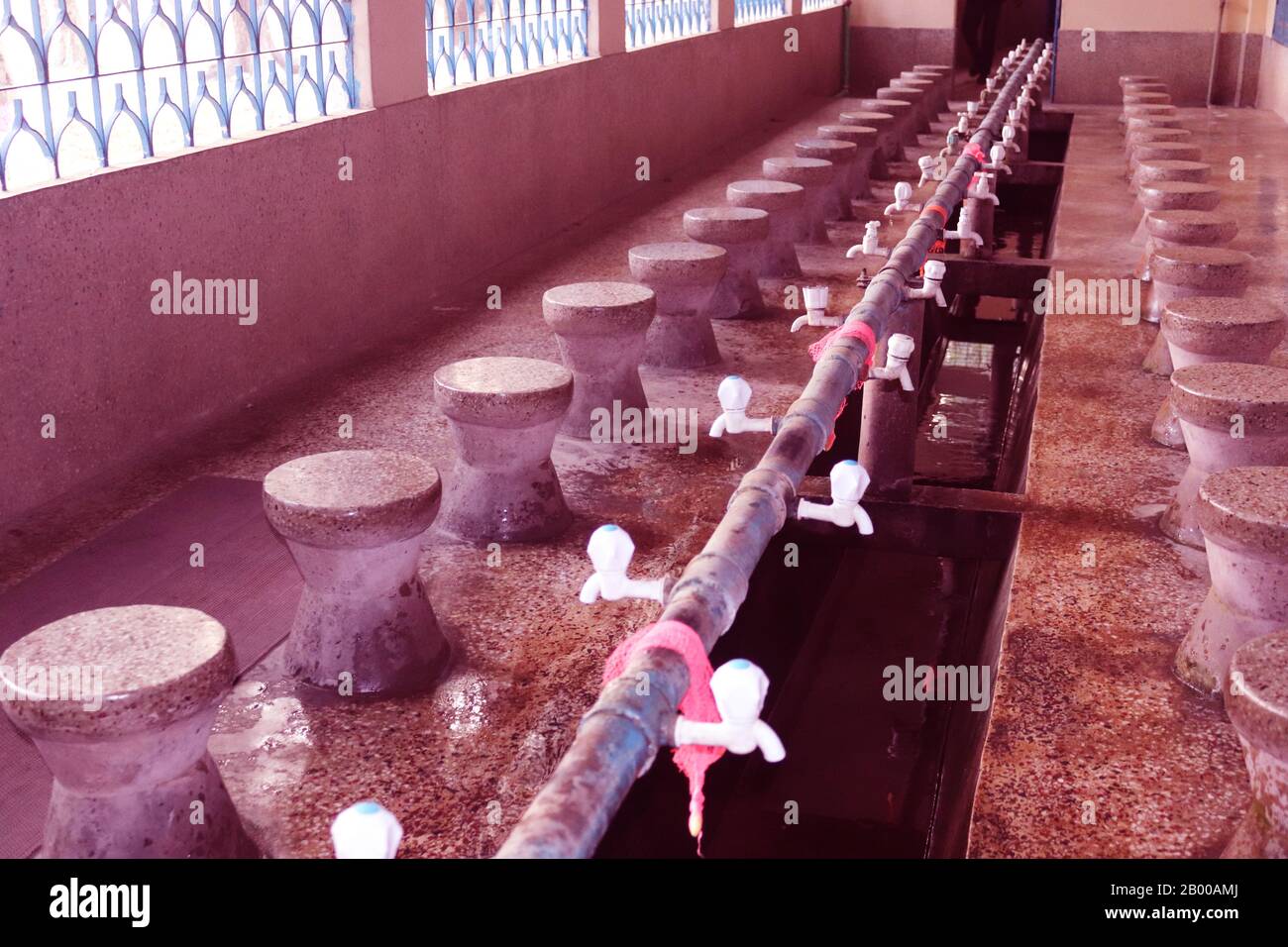 Muslim Ablution for Pray. Fountains for ablution in the Carmichael College Mosque.Water Tab for Wadu.The Wudu or Ablution area for muslim.Ablution pla Stock Photo