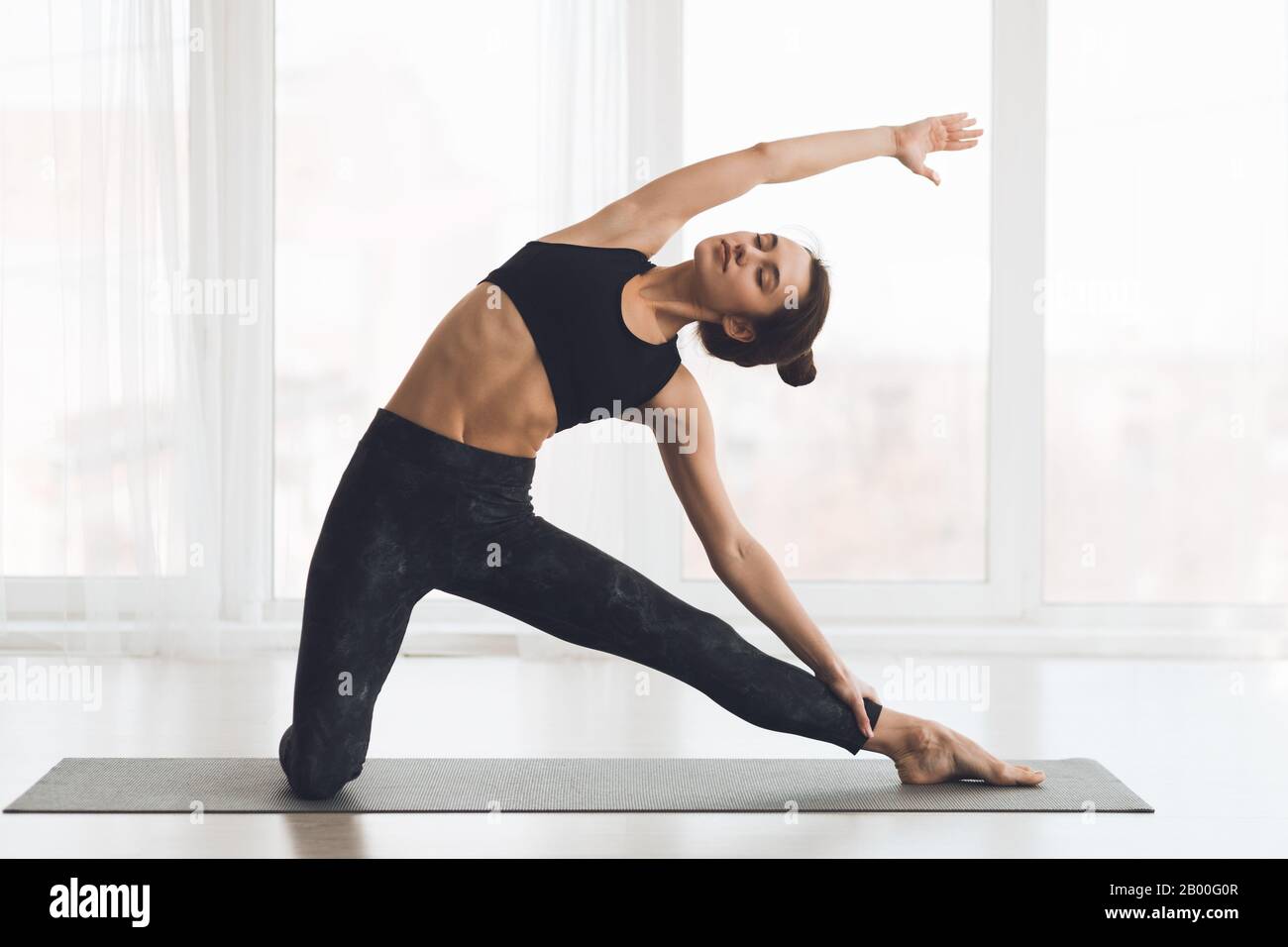Relaxed girl streching arms and legs at home Stock Photo