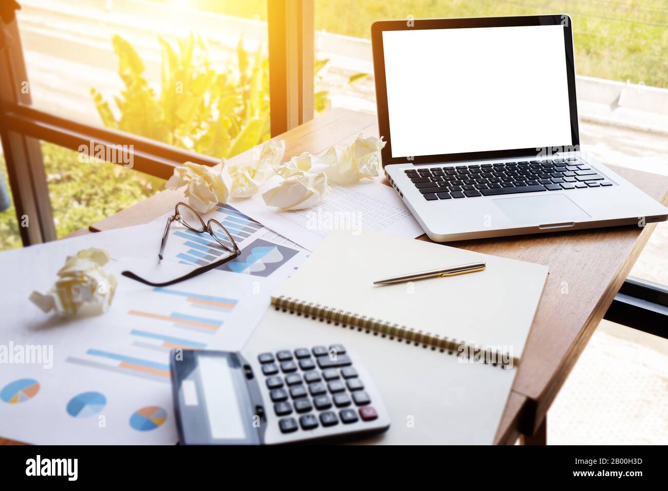 chart and graph account with calculator on table work space with blank screen computer laptop .business financial, investment, audit and analysis. Stock Photo