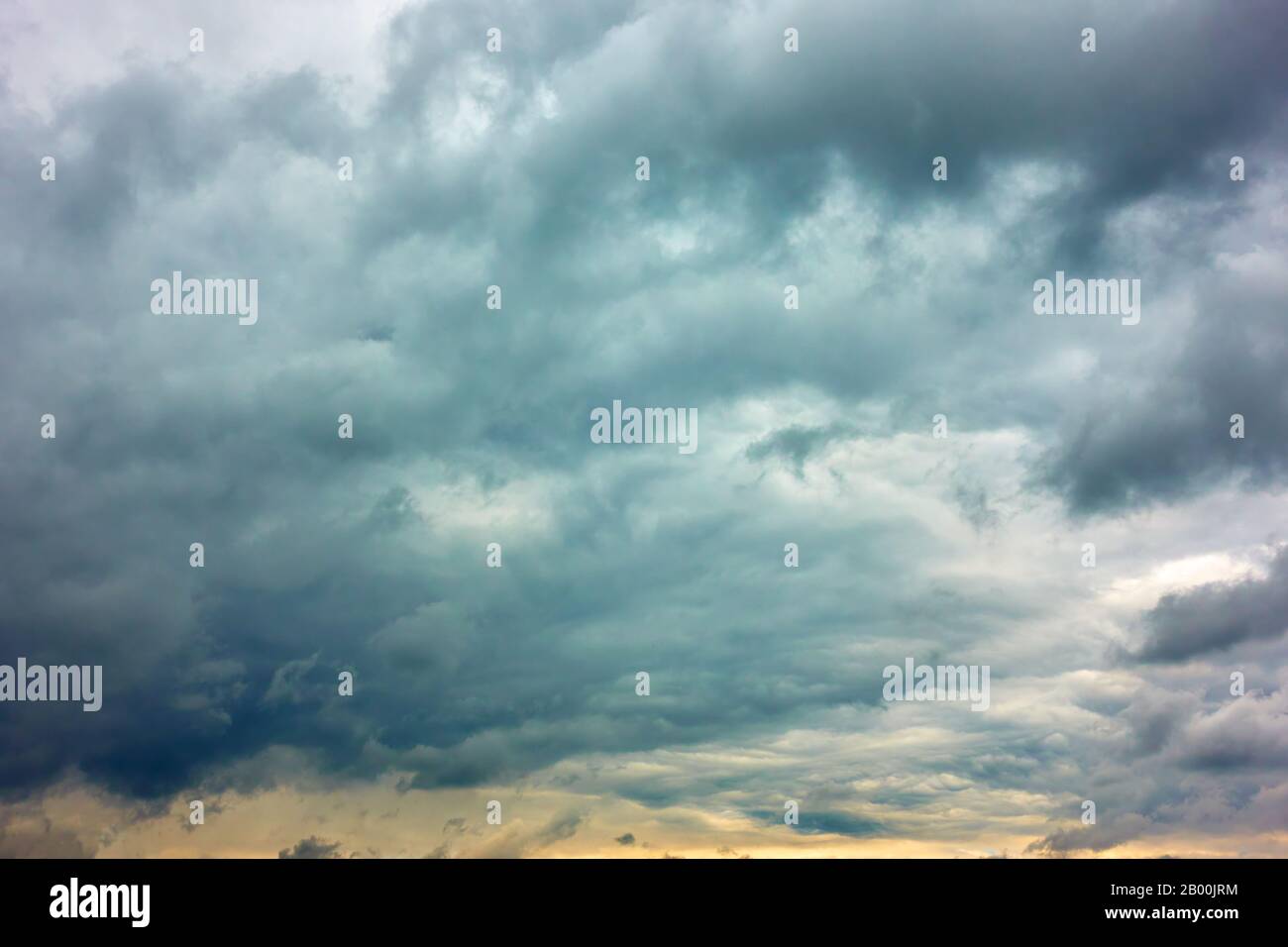 Dramatic sky with gray heavy clouds, may be used as background Stock Photo