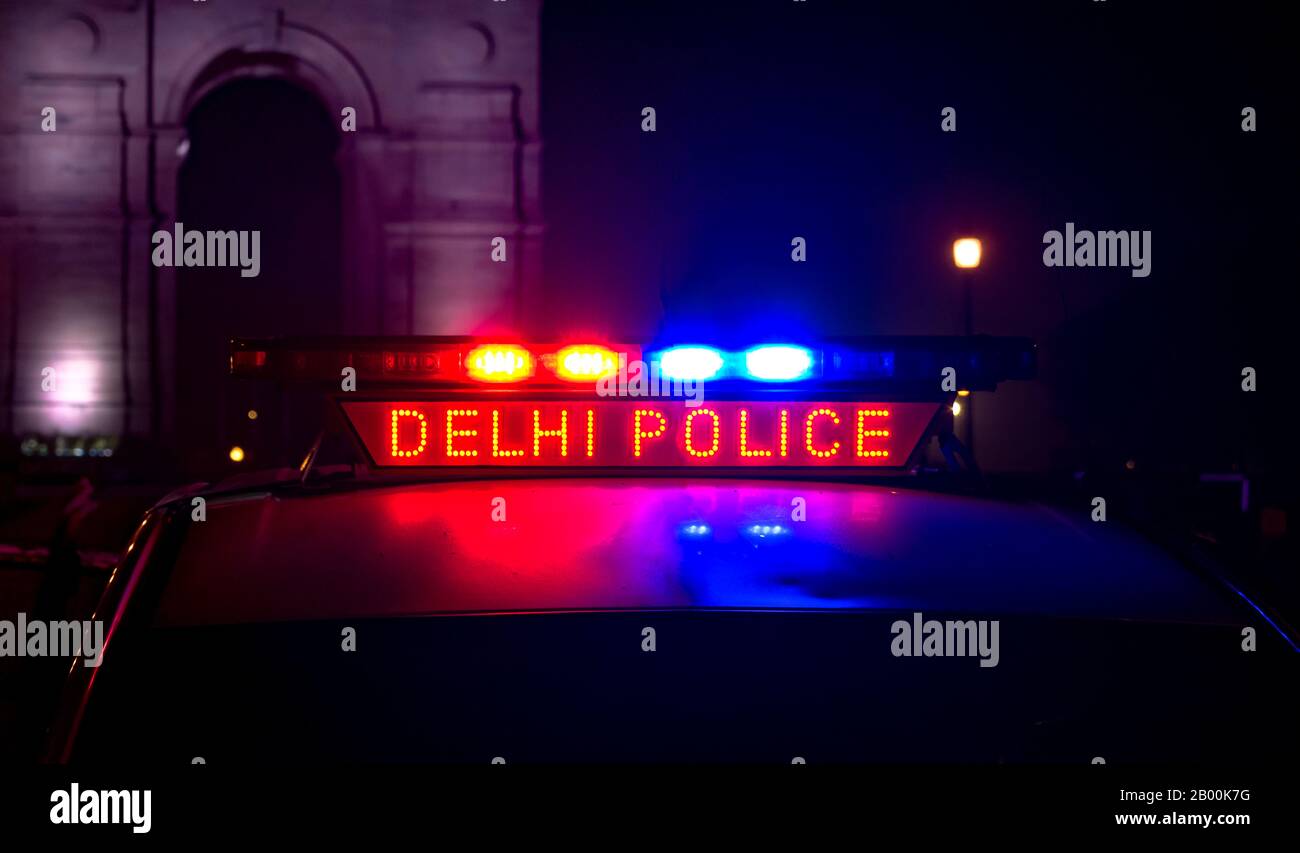 Delhi Police PCR van with siren lights, patrolling near India Gate area of Connaught Place during midnight hours to keep city safe from crime. Stock Photo