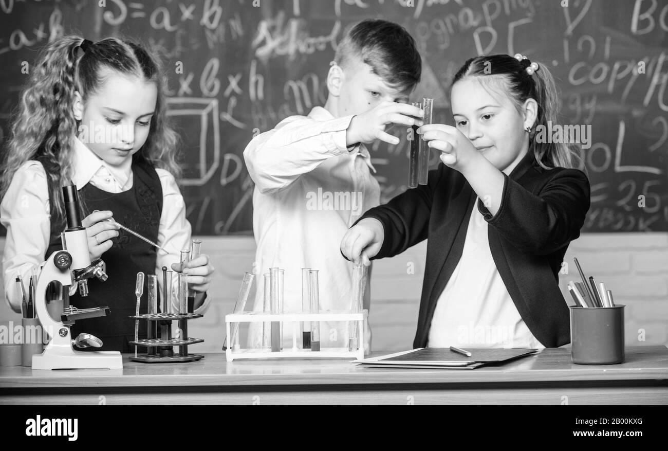 Chemistry science. Little kids scientist earning chemistry in school lab. biology experiments. Little children. Science. Lab microscope and testing tubes. Breathing life into chemistry. Stock Photo