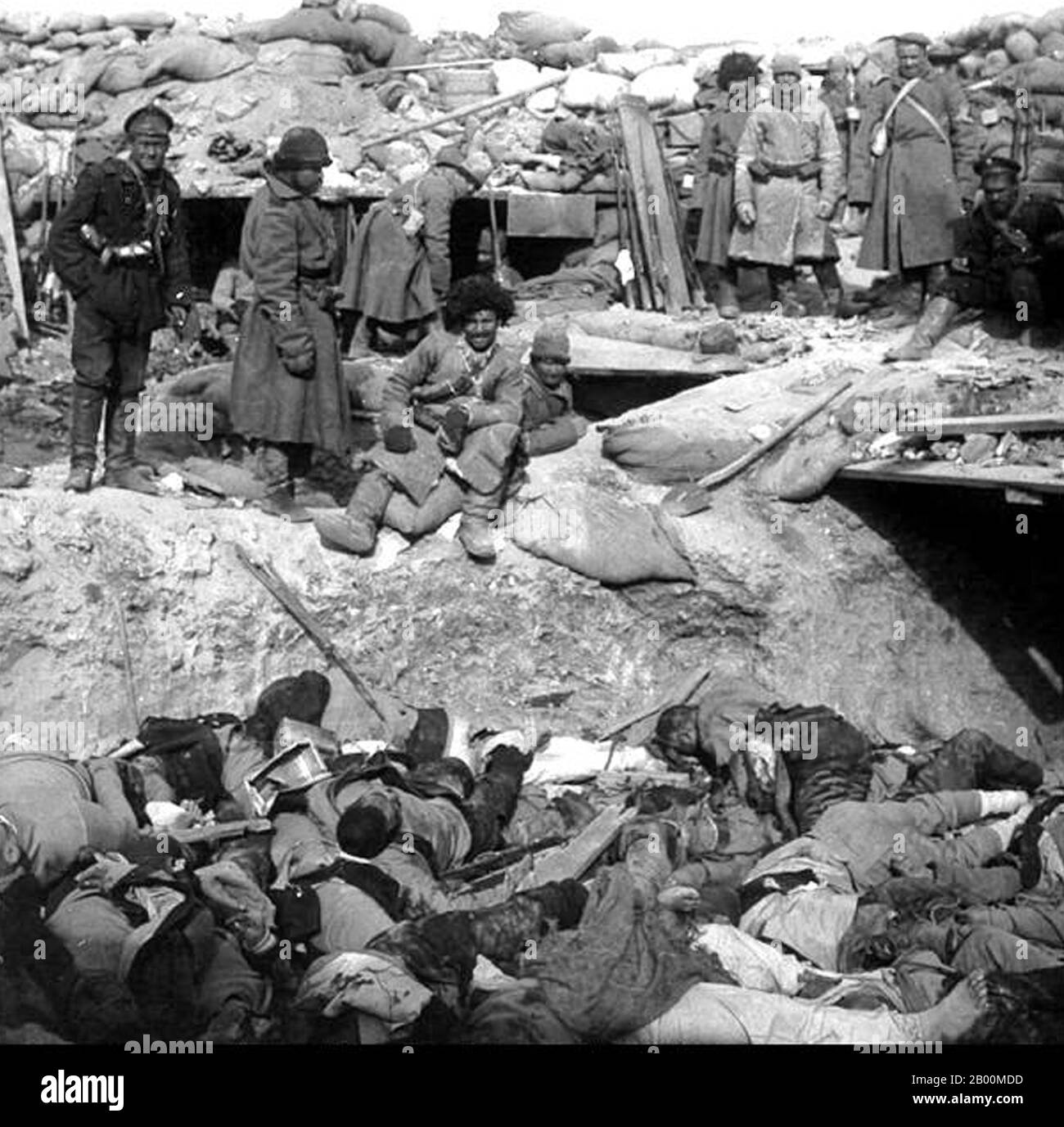 China: Battle of Mukden (Shenyang) 1905, Russian soldiers pose beside a trench filled with the corpses of Japanese soldiers, (Russo-Japanese War, 8 February 1904 – 5 September 1905).  The Russo-Japanese War (8 February 1904 – 5 September 1905) was the first great war of the 20th century which grew out of the rival imperial ambitions of the Russian Empire and Japanese Empire over Manchuria and Korea. The resulting campaigns, in which the Japanese military attained victory over the Russian forces arrayed against them, were unexpected by world observers. Stock Photo