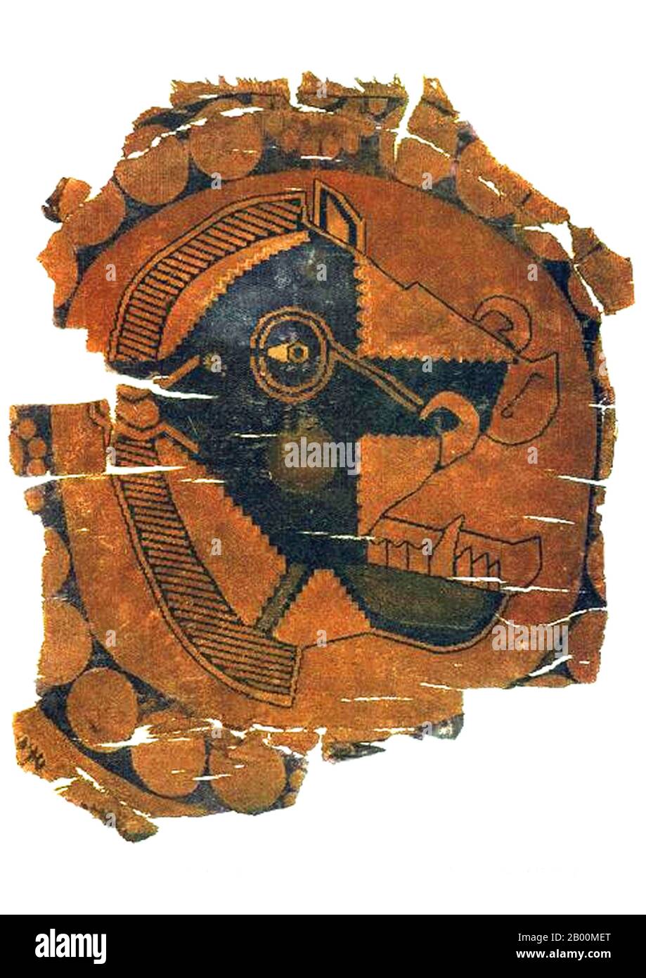 China: Fragment of silk showing a fanged beast from Xinjiang.  Gaochang is the site of an ancient oasis city built on the northern rim of the inhospitable Taklamakan Desert in Xinjiang, China. A busy trading center, it was a stopping point for merchant traders traveling on the Silk Road. The ruins are located 30 km southeast of modern Turpan. Gaochang is called Karakhoja or Qarakhoja in Uighur. The archaeological site is also known in early published reports as Chotscho, Khocho, or Qočo. Stock Photo