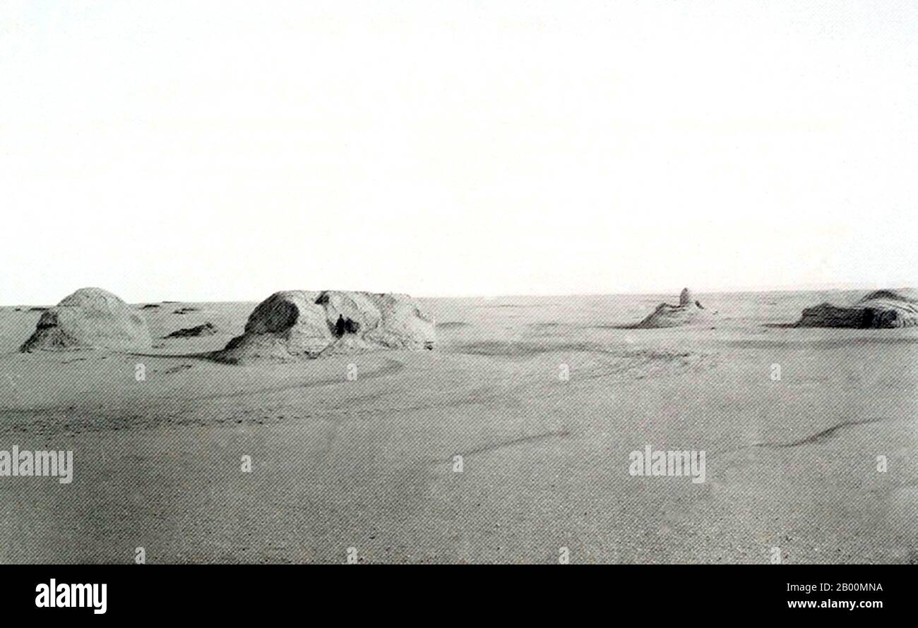 China: Buddhist stupa in the Taklamakan Desert at Miran, Xinjiang, c. 1900.  In ancient times Miran was a busy trading center on the southern part of the Silk Road, after the route split into two (the northern route and the southern route), as caravans of merchants sought to escape travel across the harsh wasteland of the desert (called by the Chinese 'The Sea of Death') and the Tarim Basin. They went by going around its north or south rim. It was also a thriving center of Buddhism with many monasteries and stupas. Marc Aurel Stein was the first archaeologist to fully study the ruins in 1907. Stock Photo