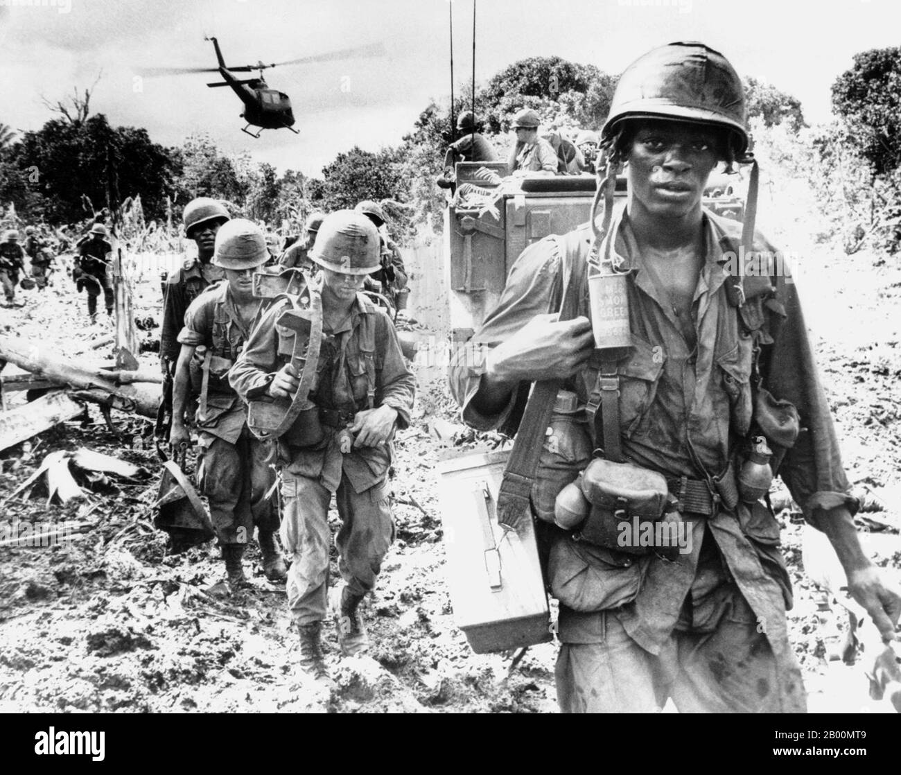 Vietnam: US soldiers on a search-and-destroy patrol in Phuoc Tuy province, South Vietnam, June 1966.  Search and Destroy, Seek and Destroy, or even simply S&D, refers to a military strategy that became a notorious component of the Vietnam War. The idea was to insert ground forces into hostile territory, search out the enemy, destroy them, and withdraw immediately afterward. The strategy was the result of a new technology, the helicopter, which resulted in a new form of warfare, the fielding of air cavalry, and was thought to be ideally suited to counter-guerrilla jungle warfare. Stock Photo