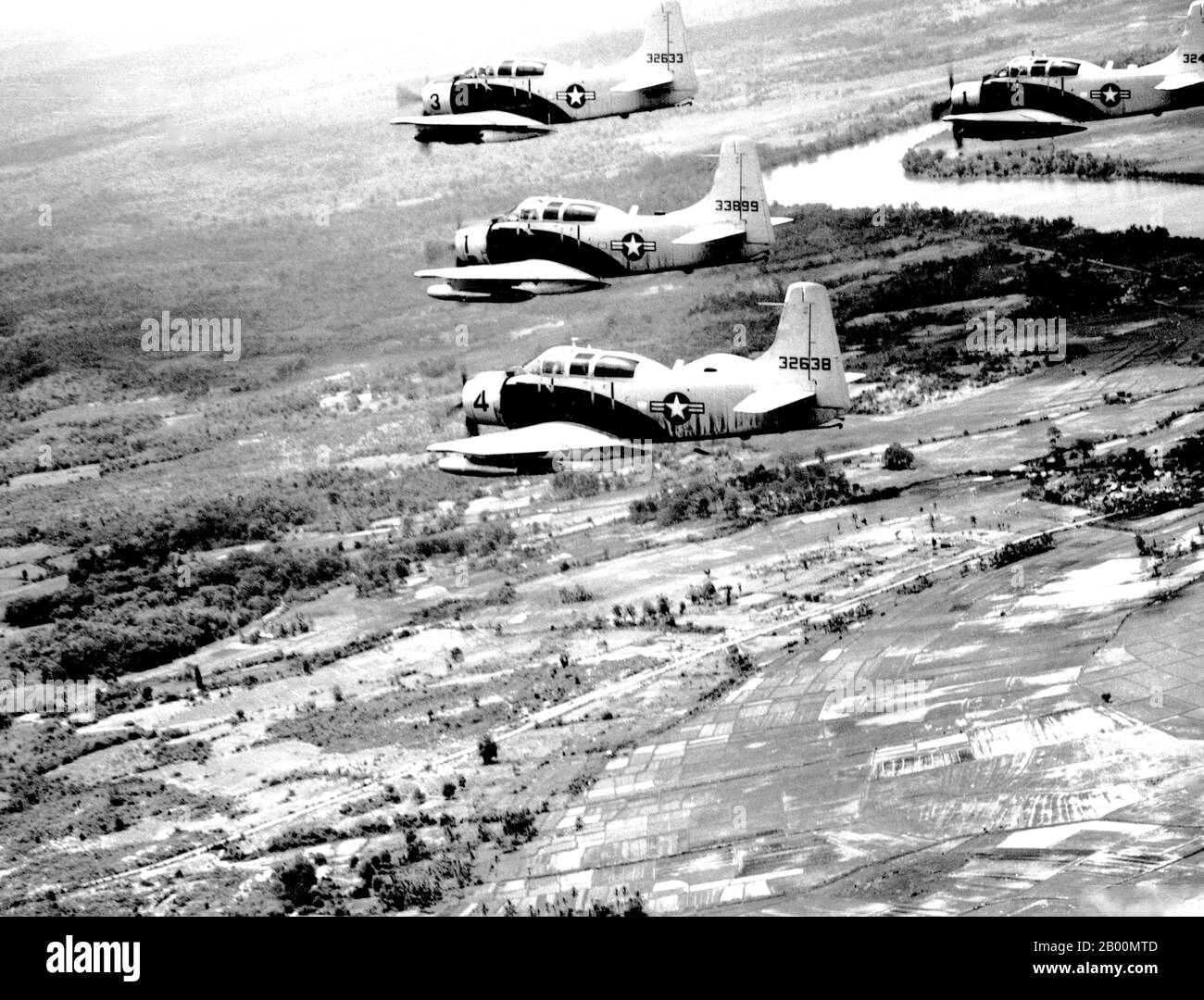 Vietnam: A-1E Skyraider aircraft of the 34th Tactical Group, based at Bien Hoa, South Vietnam, fly in formation over South Vietnam on way to target on June 25, 1965.  The Second Indochina War, known in America as the Vietnam War, was a Cold War era military conflict that occurred in Vietnam, Laos, and Cambodia from 1 November 1955 to the fall of Saigon on 30 April 1975. This war followed the First Indochina War and was fought between North Vietnam, supported by its communist allies, and the government of South Vietnam, supported by the U.S. and other anti-communist nations. Stock Photo