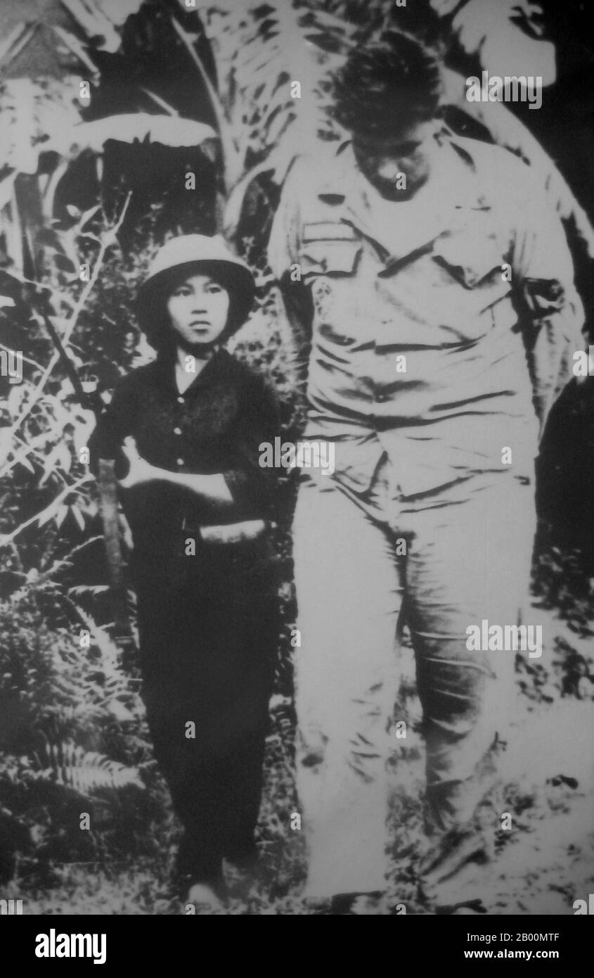 Vietnam: A very large USAF pilot shot down over North Vietnam under arrest by diminutive Vietnamese female soldier.  The Second Indochina War, known in America as the Vietnam War, was a Cold War era military conflict that occurred in Vietnam, Laos, and Cambodia from 1 November 1955 to the fall of Saigon on 30 April 1975. This war followed the First Indochina War and was fought between North Vietnam, supported by its communist allies, and the government of South Vietnam, supported by the U.S. and other anti-communist nations. Stock Photo