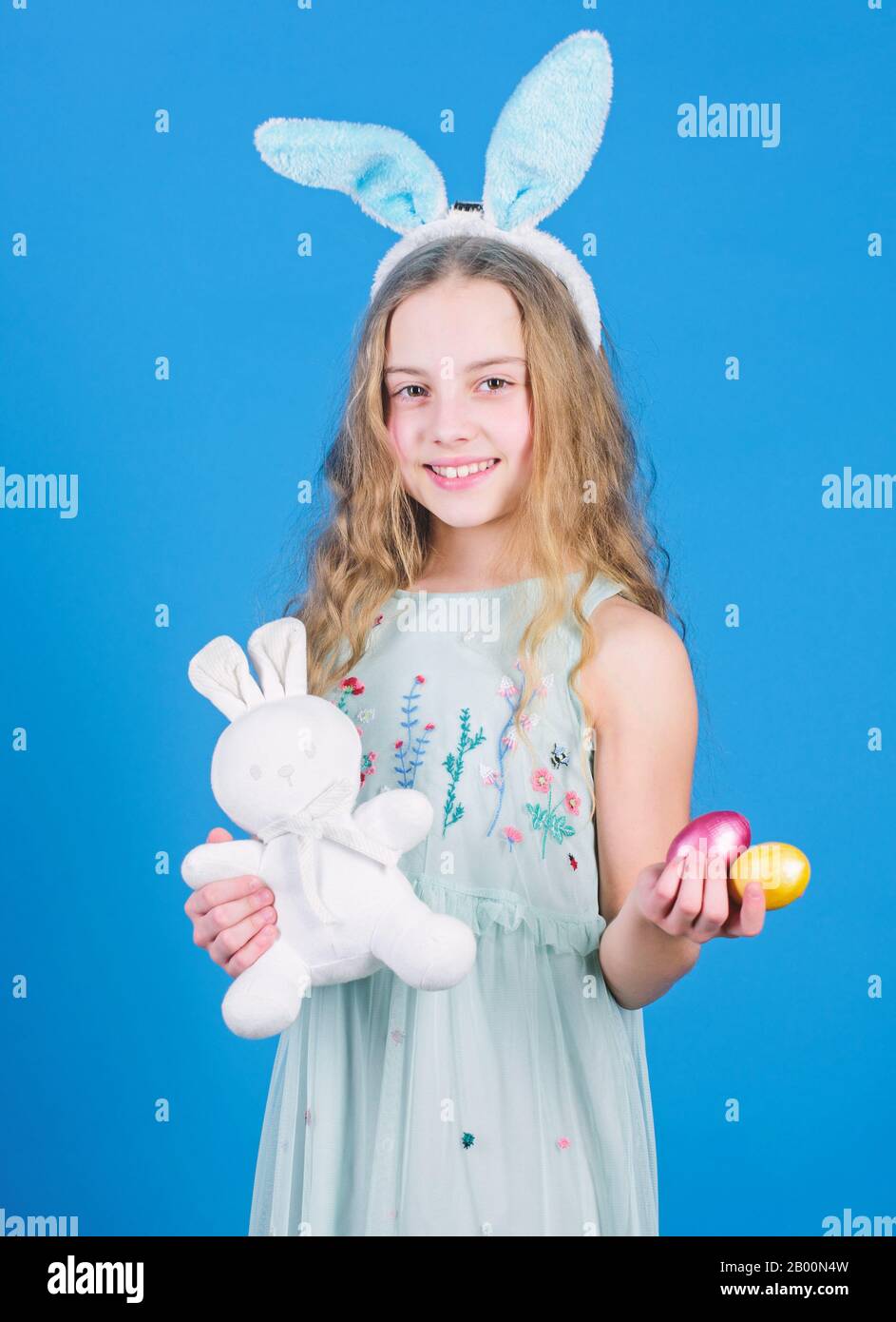 Holiday bunny girl with long bunny ears. Child cute bunny costume. Happy  easter. Playful baby celebrate easter. Spring holiday. Happy childhood.  Ready for Easter day. Easter activities for children Stock Photo -