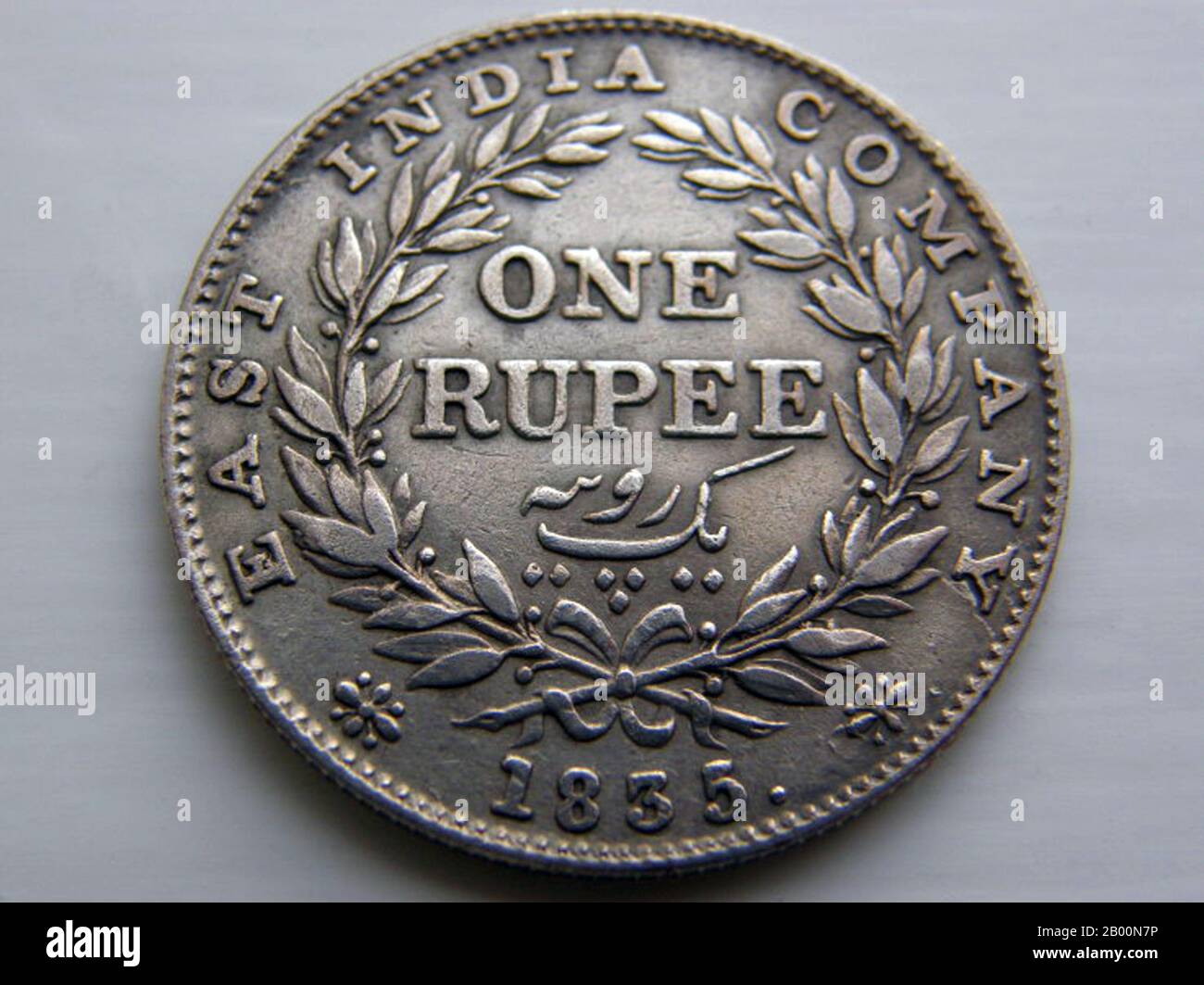 India: British East India Company, King William III, one rupee, 1835.  The East India Company (also the East India Trading Company, English East India Company, and then the British East India Company) was an early English joint-stock company that was formed initially for pursuing trade with the East Indies, but that ended up trading mainly with the Indian subcontinent and China. The oldest among several similarly formed European East India Companies, the Company was granted an English Royal Charter by Elizabeth I on 31 December 1600. It ceased to trade in 1857. Stock Photo