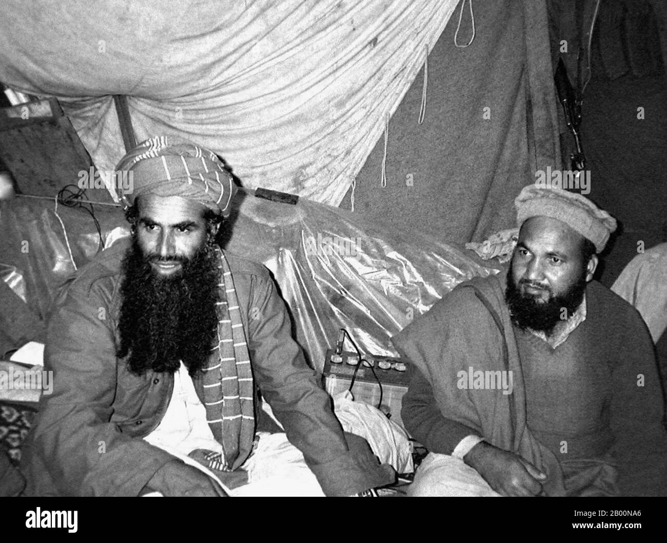 Afghanistan: Mujahideen military commander Abdul Rasul Sayyaf (L) with one of his top lieutenants, Commander Abdullah, Pakti Province, 1984. Photo by Erwin Franzen.  The Soviet War in Afghanistan was a nine-year conflict involving the Soviet Union, supporting the Marxist government of the Democratic Republic of Afghanistan against the indigenous Afghan Mujahideen and foreign ‘Arab–Afghan’ volunteers. The mujahideen found other support from a variety of sources including the United States, Saudi Arabia, the United Kingdom, Pakistan, Egypt, China and other nations, turning it into a proxy war. Stock Photo