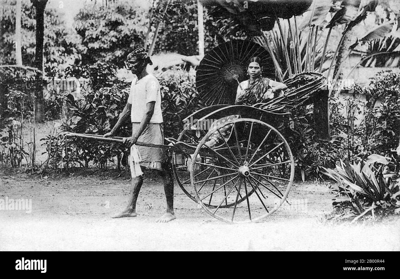 Sri Lanka: Ceylonese woman (apparently Tamil) posing in a rickshaw with rickshaw puller, c. 1900.  Sri Lanka had always been an important port and trading post in the ancient world, and was increasingly frequented by merchant ships from the Middle East, Persia, Burma, Thailand, Malaysia, Indonesia and other parts of Southeast Asia. The islands were known to the first European explorers of South Asia and settled by many groups of Arab and Malay merchants. Stock Photo