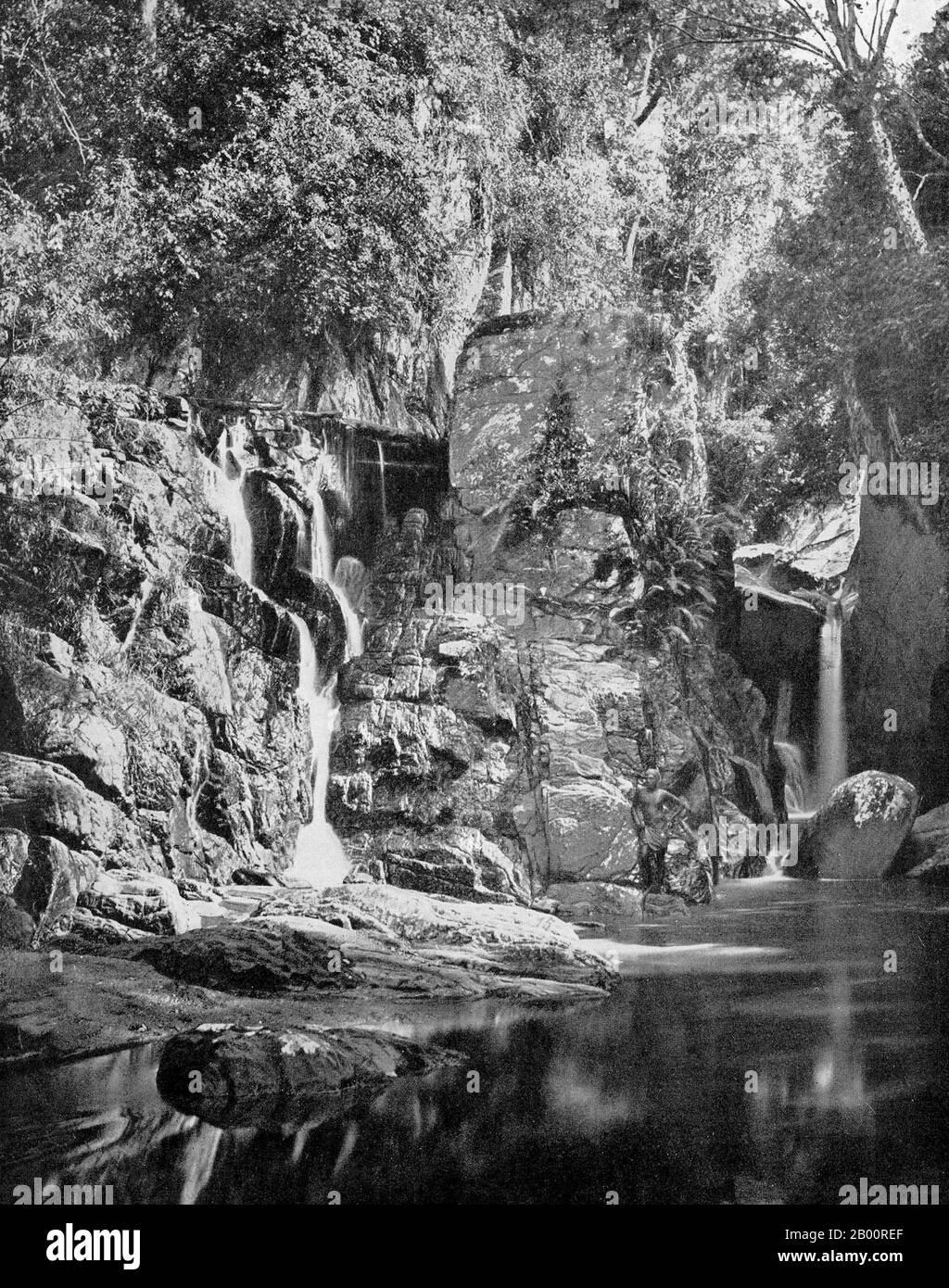 Sri Lanka: A waterfall near Kandy, Central Highlands. Photograph by Ernst Haeckel (1834-1919), early 20th century.  Ernst Heinrich Philipp August Haeckel (February 16, 1834 – August 9, 1919), also written von Haeckel, was an eminent German biologist, naturalist, philosopher, physician, professor and artist who discovered, described and named thousands of new species, mapped a genealogical tree relating all life forms, and coined many terms in biology, including anthropogeny, ecology, phylum, phylogeny, and the kingdom Protista. Haeckel promoted and popularized Charles Darwin's work in Germany. Stock Photo