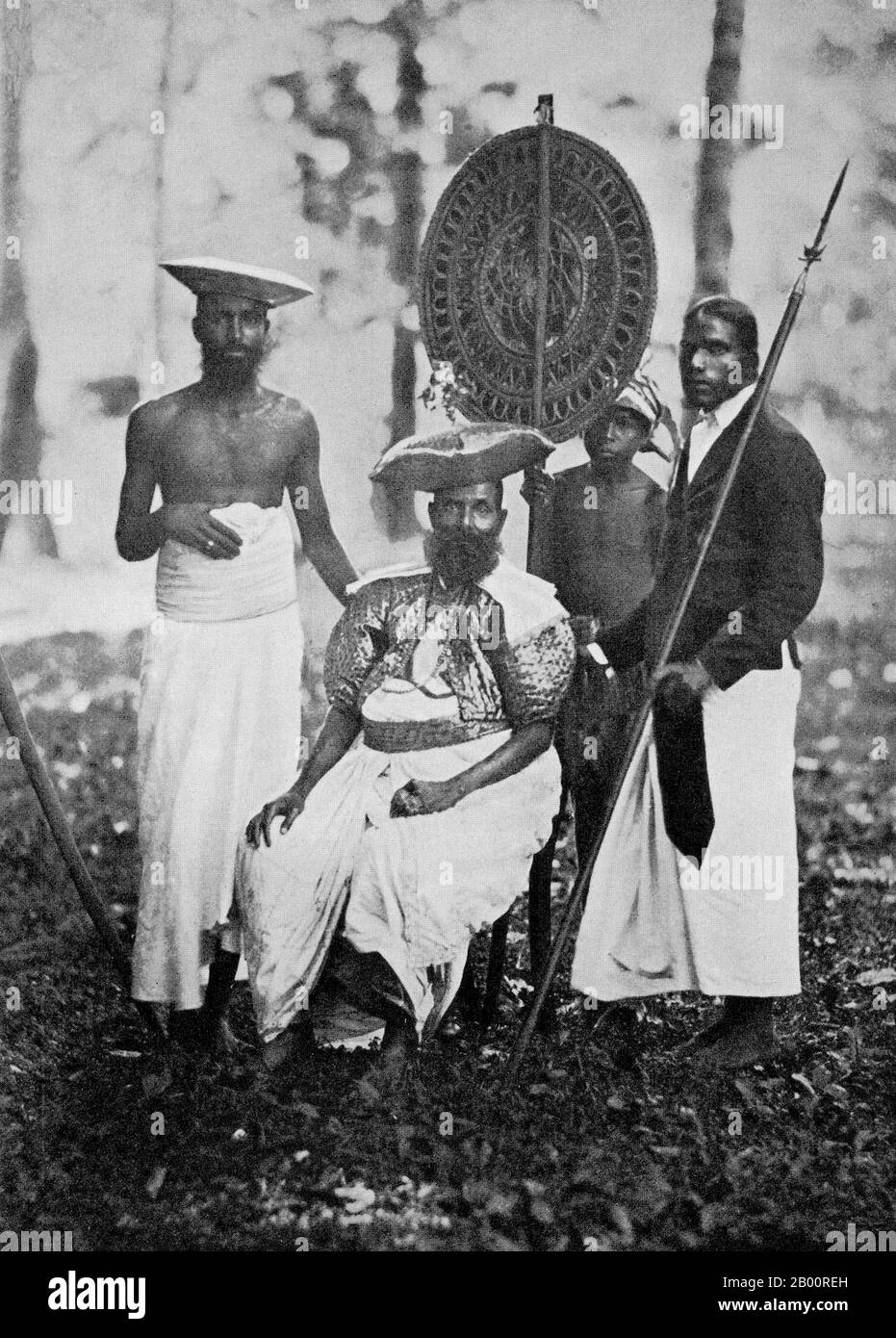 Sri Lanka: A Kandyan chief with his retainers. Photograph by Charles T. Scowen (1852-1948), c. 1870s.  Charles Thomas Scowen (11 March 1852 - 24 November 1948) was a British photographer active during the late nineteenth century, primarily from 1871-1890. He worked out of Sri Lanka and British India with his own established studio, Scowen & Co. His first studio was in Kandy, but he had opened a second in Colombo by the 1890s. His photos were famed for their lighting, strong compositional qualities and technically superior printing. Stock Photo