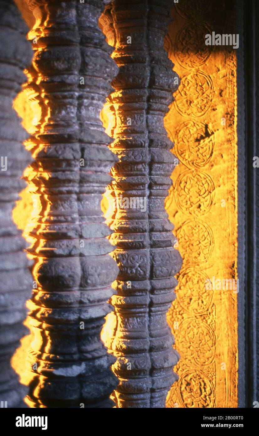 Cambodia: Window balusters high up in the central sanctuary at sunset, Angkor Wat.  Angkor Wat was built for King Suryavarman II (ruled 1113-50) in the early 12th century as his state temple and capital city. As the best-preserved temple at the Angkor site, it is the only one to have remained a significant religious centre since its foundation – first Hindu, dedicated to the god Vishnu, then Buddhist.  It is the world's largest religious building. The temple is at the top of the high classical style of Khmer architecture. It has become a symbol of Cambodia, appearing on its national flag. Stock Photo