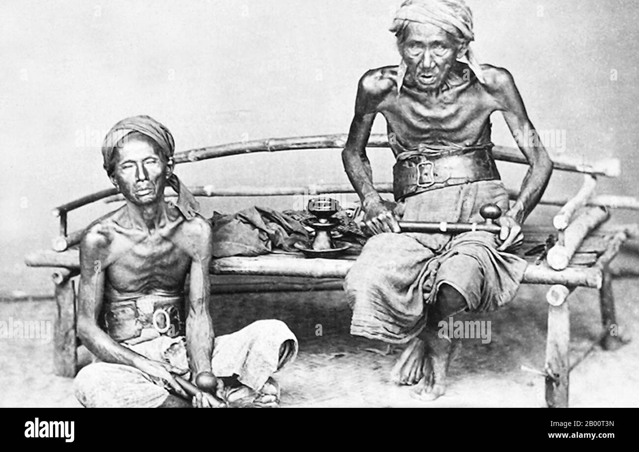 Indonesia: Two Opium Smokers on Java, 19th century.  Two opium smokers on the island of Java. Opium smoking was introduced into Java by the Dutch, who established a major port at Batavia (present-day Jakarta) and imported Indian-grown opium for local sale and later for re-export to China. Opium smoking was at first mainly a part of social life among Javanese upper classes, but in the 19th century it increasingly spread to the laborers who served the expanding colonial economy. The photograph was taken by the British firm of Woodbury & Page, which was established in the 1850s. Stock Photo