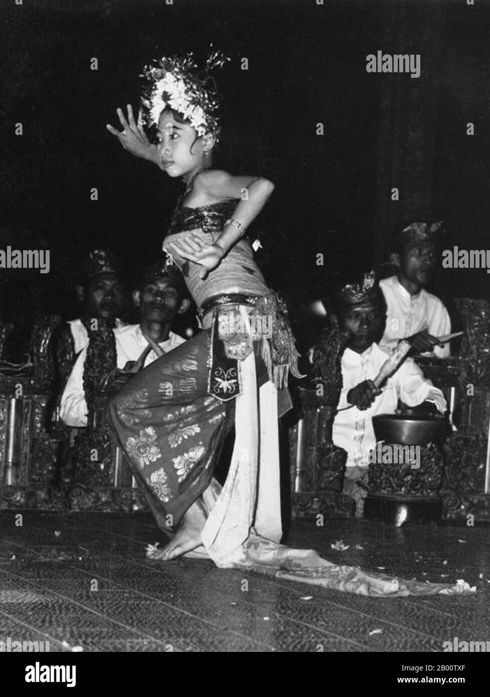 Indonesia: A legong dancer performs on the Island of Bali. Photo by Boy Lawson (1925-1992),1971 (Tropenmuseum, part of the National Museum of World Cultures, CC BY-SA 3.0 License).  Bali is home to most of Indonesia's small Hindu minority with some 92% of the island’s 4 million population adhering to Balinese Hinduism, while most of the remainder follow Islam.   Bali is the largest tourist destination in Indonesia, and is renowned for its highly developed arts, including traditional and modern dance, sculpture, painting, leatherwork, metalwork and music. Stock Photo
