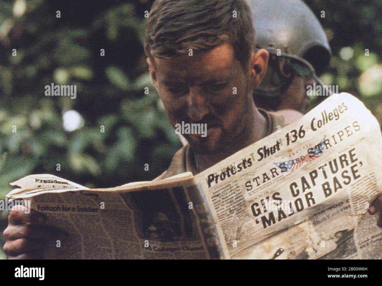 Cambodia: A US soldier reads 'Stars and Stripes' during a break in the US-South Vietnamese invasion of Cambodia, 1970.  The Second Indochina War, known in America as the Vietnam War, was a Cold War era military conflict that occurred in Vietnam, Laos, and Cambodia from 1 November 1955 to the fall of Saigon on 30 April 1975. This war followed the First Indochina War and was fought between North Vietnam, supported by its communist allies, and the government of South Vietnam, supported by the U.S. and other anti-communist nations. Stock Photo