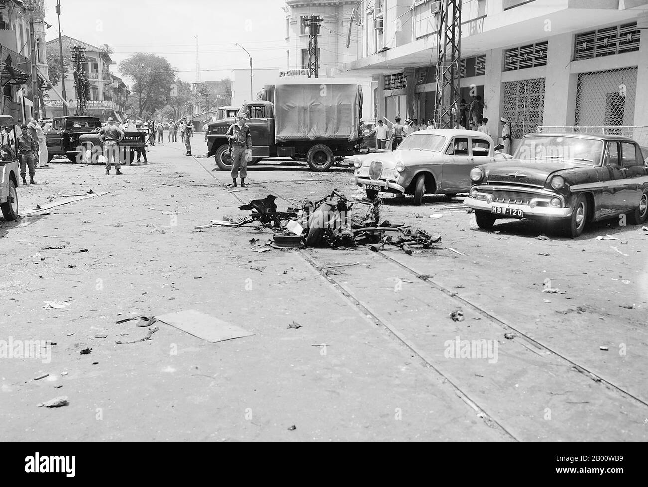 Vietnam: Aftermath of a street bombing attributed to the NLF (Viet Cong) in Saigon, c. 1965.  The Second Indochina War, known in America as the Vietnam War, was a Cold War era military conflict that occurred in Vietnam, Laos, and Cambodia from 1 November 1955 to the fall of Saigon on 30 April 1975. This war followed the First Indochina War and was fought between North Vietnam, supported by its communist allies, and the government of South Vietnam, supported by the U.S. and other anti-communist nations. Stock Photo