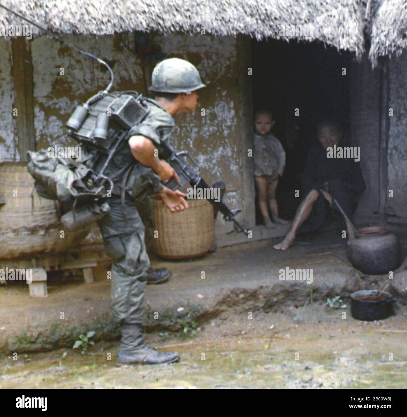 Vietnam: ARVN (Army of the Republic of Vietnam) soldier interrogating villagers, South Vietnam, c. 1965.  The Army of the Republic of Vietnam (ARVN) was the land-based military forces of the Republic of Vietnam (South Vietnam), which existed from October 26, 1955 until the fall of Saigon on April 30, 1975. After the fall of Saigon and the communist victory, the ARVN was dissolved. While some members had fled the country to the United States or elsewhere, hundreds of thousands of former ARVN soldiers were sent to reeducation camps by the newly unified Vietnamese communist government. Stock Photo