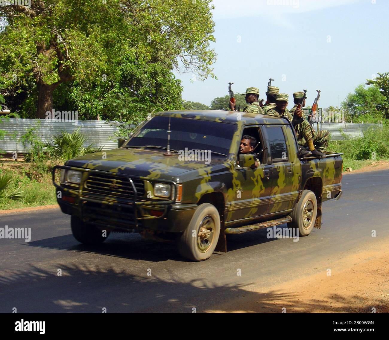 Sri Lanka: Armed Tamil Tiger (LTTE) troops in the back of a camouflaged pickup truck somewhere in the Wanni region, c. 2006.   The Liberation Tigers of Tamil Eelam, commonly known as the LTTE or the Tamil Tigers, was a separatist organisation formerly based in northern Sri Lanka. Founded in May 1976 by Velupillai Prabhakaran, it waged a violent secessionist campaign that sought to create Tamil Eelam, an independent state in the north and east of Sri Lanka. This campaign evolved into the Sri Lankan Civil War, which was one of the longest running armed conflicts in Asia until its end in 2008. Stock Photo