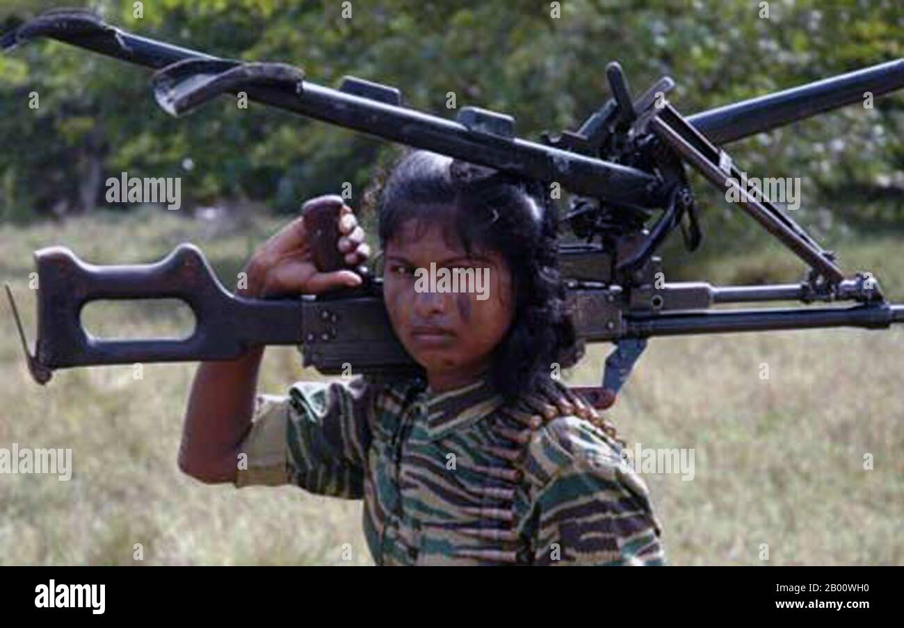 Sri Lanka: Female LTTE (Liberation Tigers of Tamil Eelam) soldier posing for LTTE publicity photograph with a heavy machine gun, c. 2008.  The Sri Lankan Civil War began on July 23, 1983, and quickly developed into an on-and-off insurgency against the Colombo government by the Liberation Tigers of Tamil Eelam (LTTE), commonly known as the Tamil Tigers, and other few rebel groups, which were fighting to create an independent Tamil state named Tamil Eelam in the north and the east of the island. After a 26-year military campaign, the Sri Lankan military defeated the Tamil Tigers in May 2009. Stock Photo