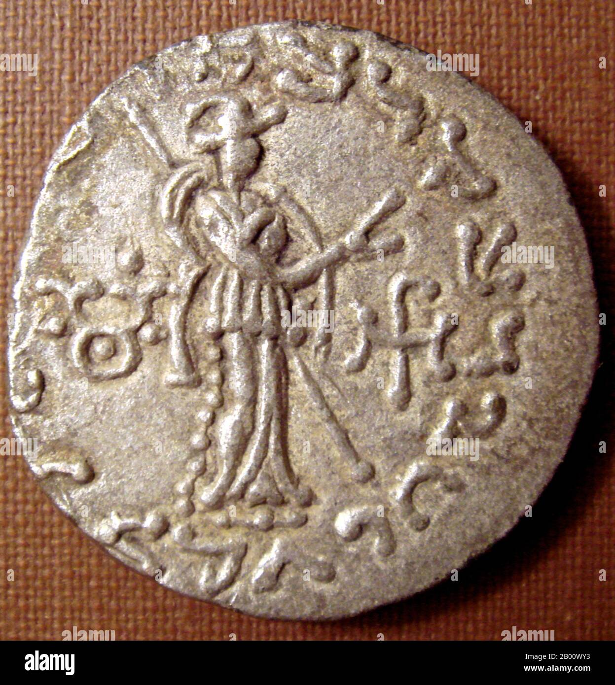 India: Silver coin of King Azes II (r.c. 35-12 BCE). Buddhist triratna symbol in the left field on the reverse.  Azes II (reigned circa 35-12 BCE), may have been the last Indo-Scythian king in northern India. After the death of Azes II, the rule of the Indo-Scythians in northwestern India finally crumbled with the conquest of the Kushans, one of the five tribes of the Yuezhi who had lived in Bactria for more than a century, and who were then expanding into India to create a Kushan Empire. Stock Photo