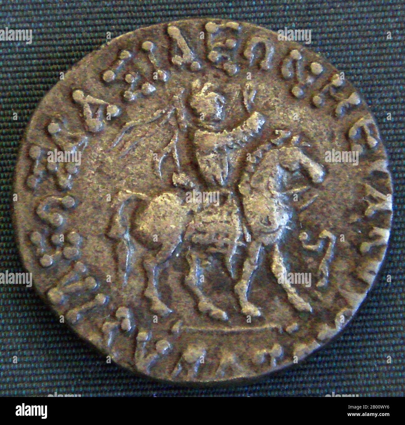 India: Coin of Azes II, with a clear depiction of his military outfit, with coat of mail and reflex bow in the saddle. Photo by PHGCOM (CC BY-SA 3.0 License).  Azes II (reigned circa 35-12 BCE), may have been the last Indo-Scythian king in northern India. After the death of Azes II, the rule of the Indo-Scythians in northwestern India finally crumbled with the conquest of the Kushans, one of the five tribes of the Yuezhi who had lived in Bactria for more than a century, and who were then expanding into India to create a Kushan Empire. Stock Photo